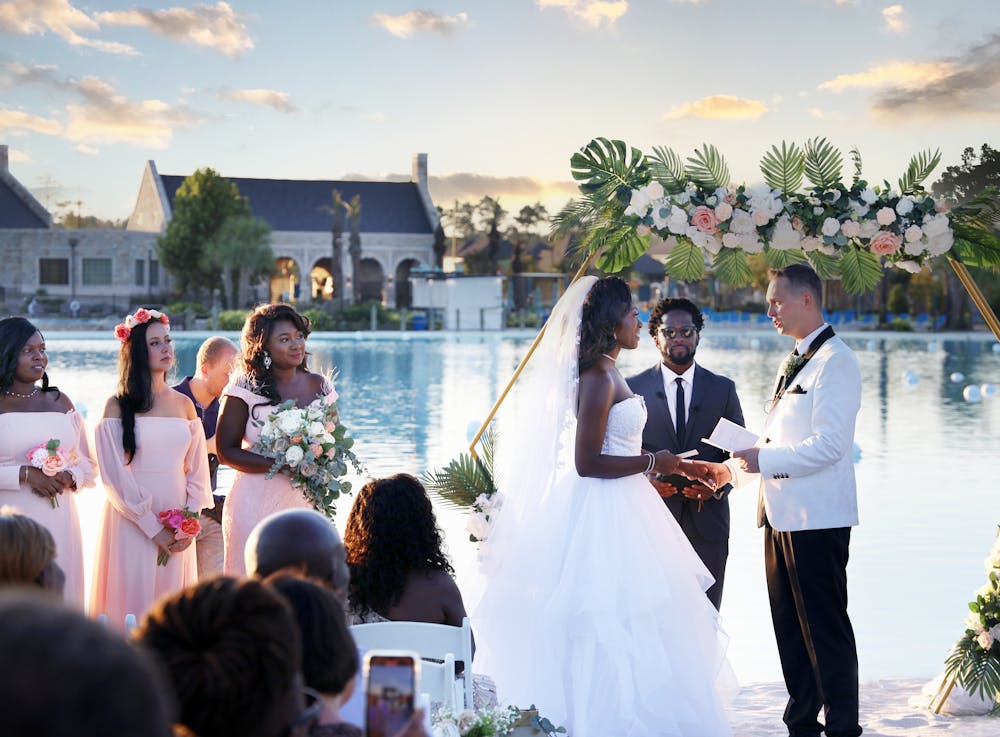 a group of people standing in front of water