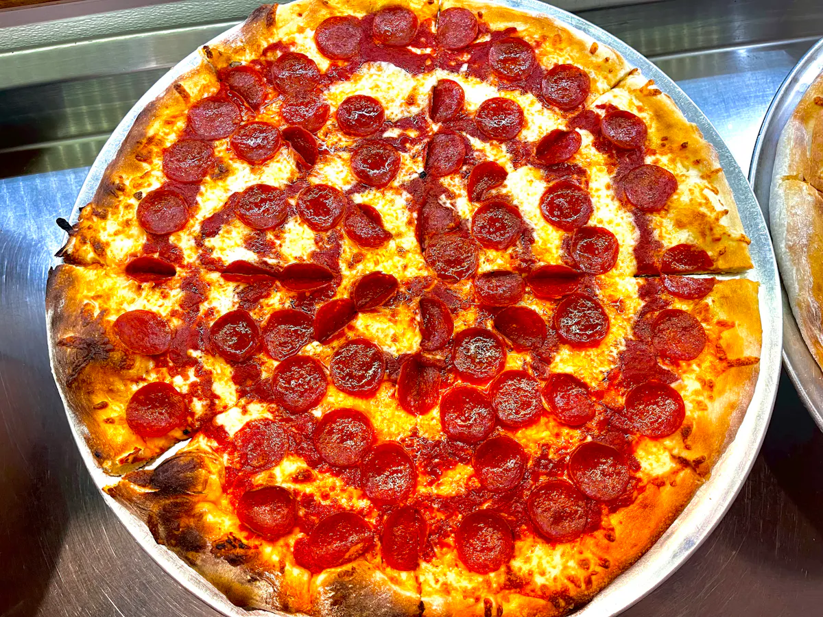 a pizza sitting on top of a pan on a table