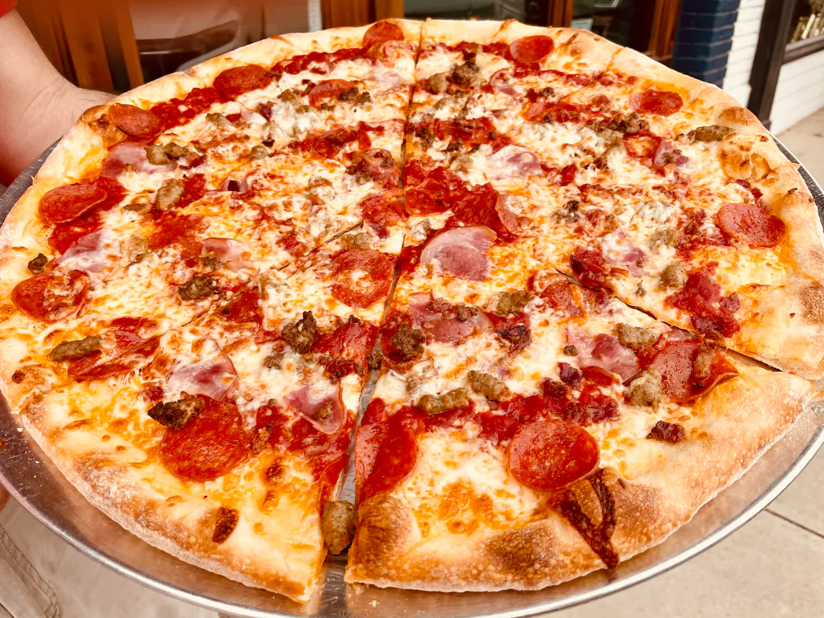 a pizza sitting on top of a metal pan