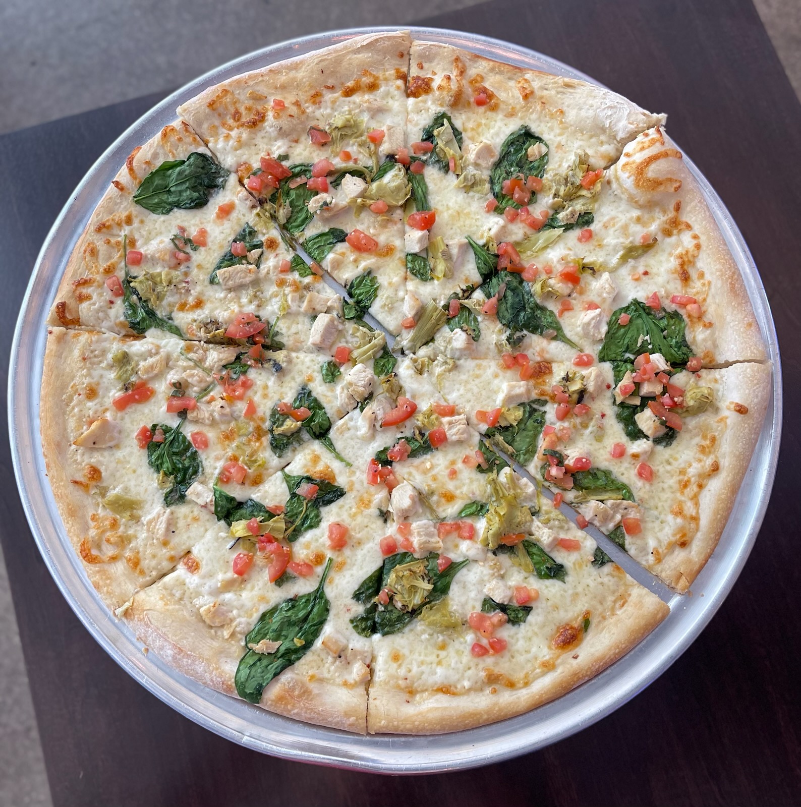 a pizza sitting on top of a plate of food
