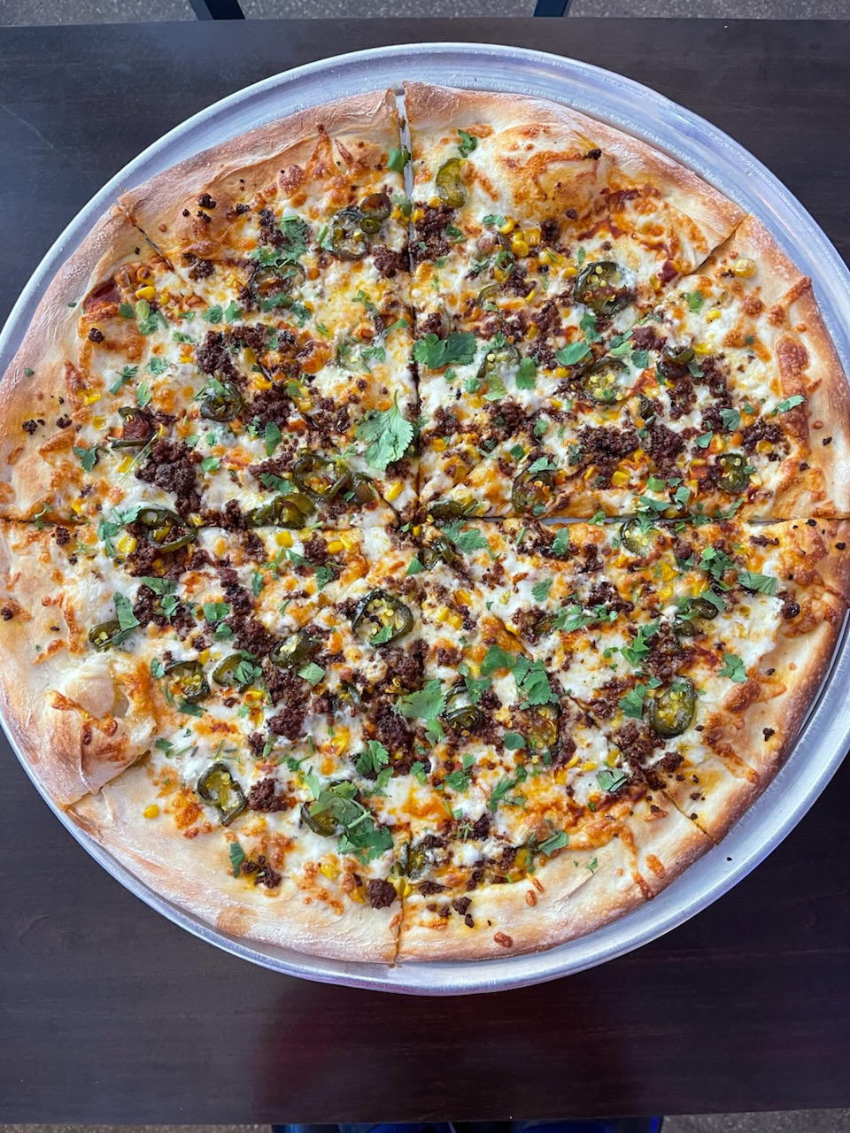 a pizza sitting on top of a pan on a table