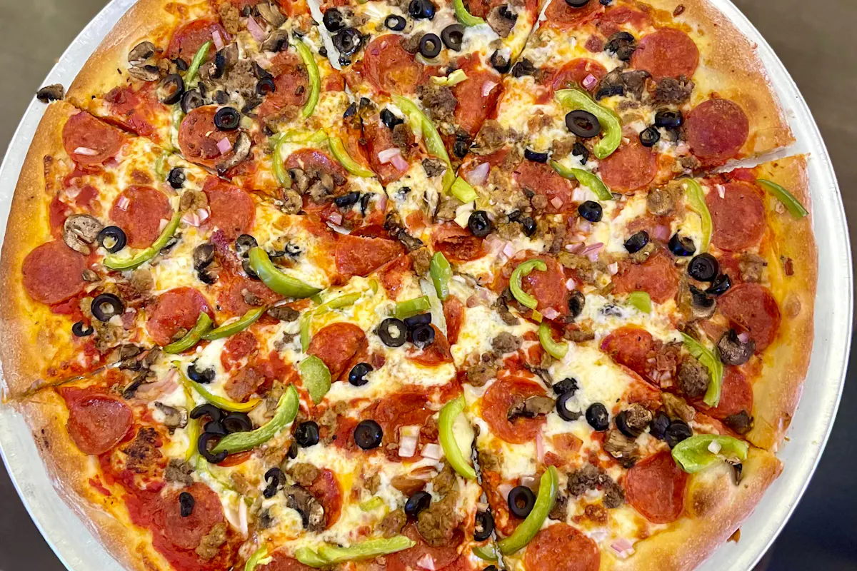 a pizza sitting on top of a plate of food