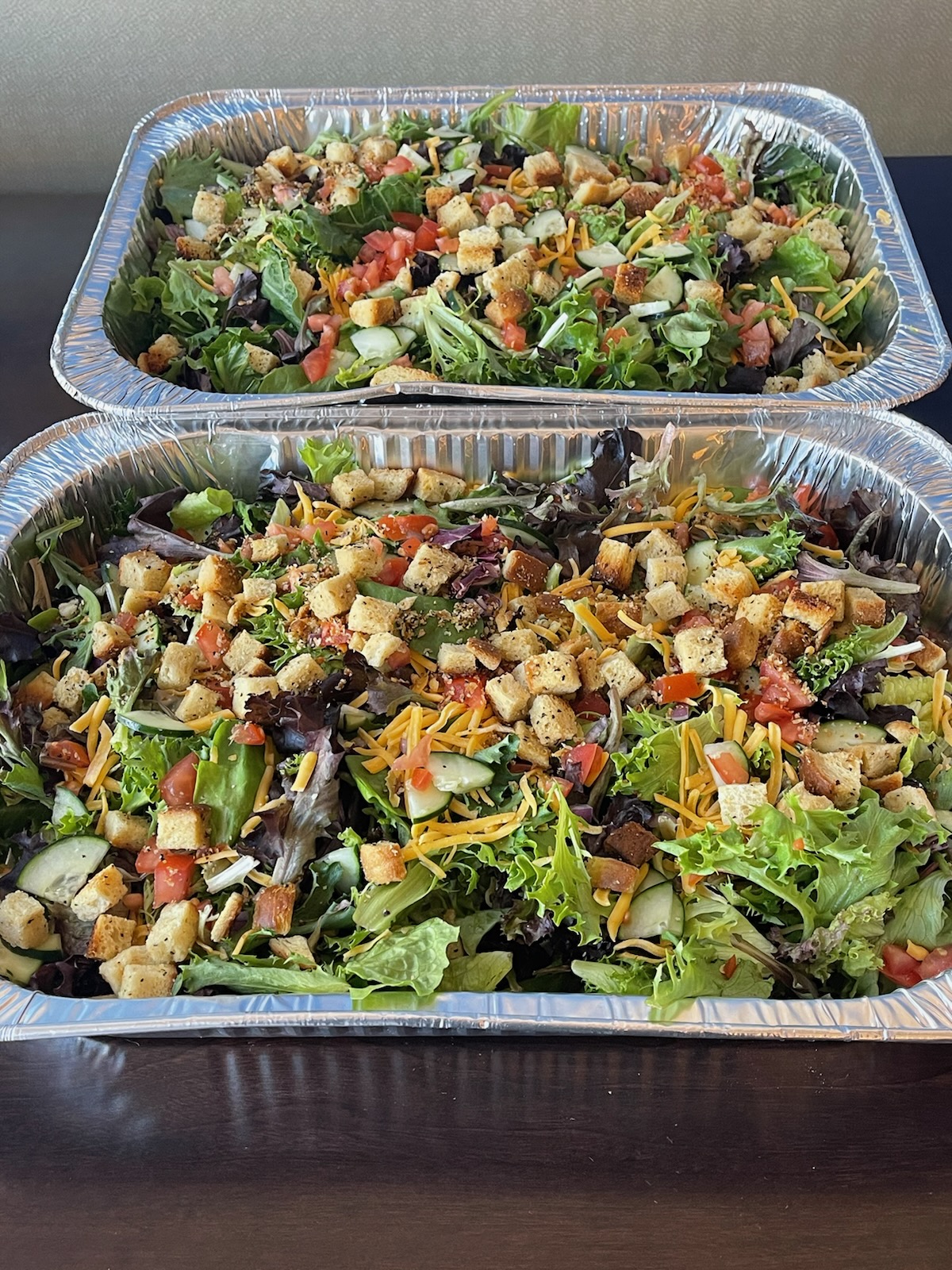 a meal of pizza and salad on a tray