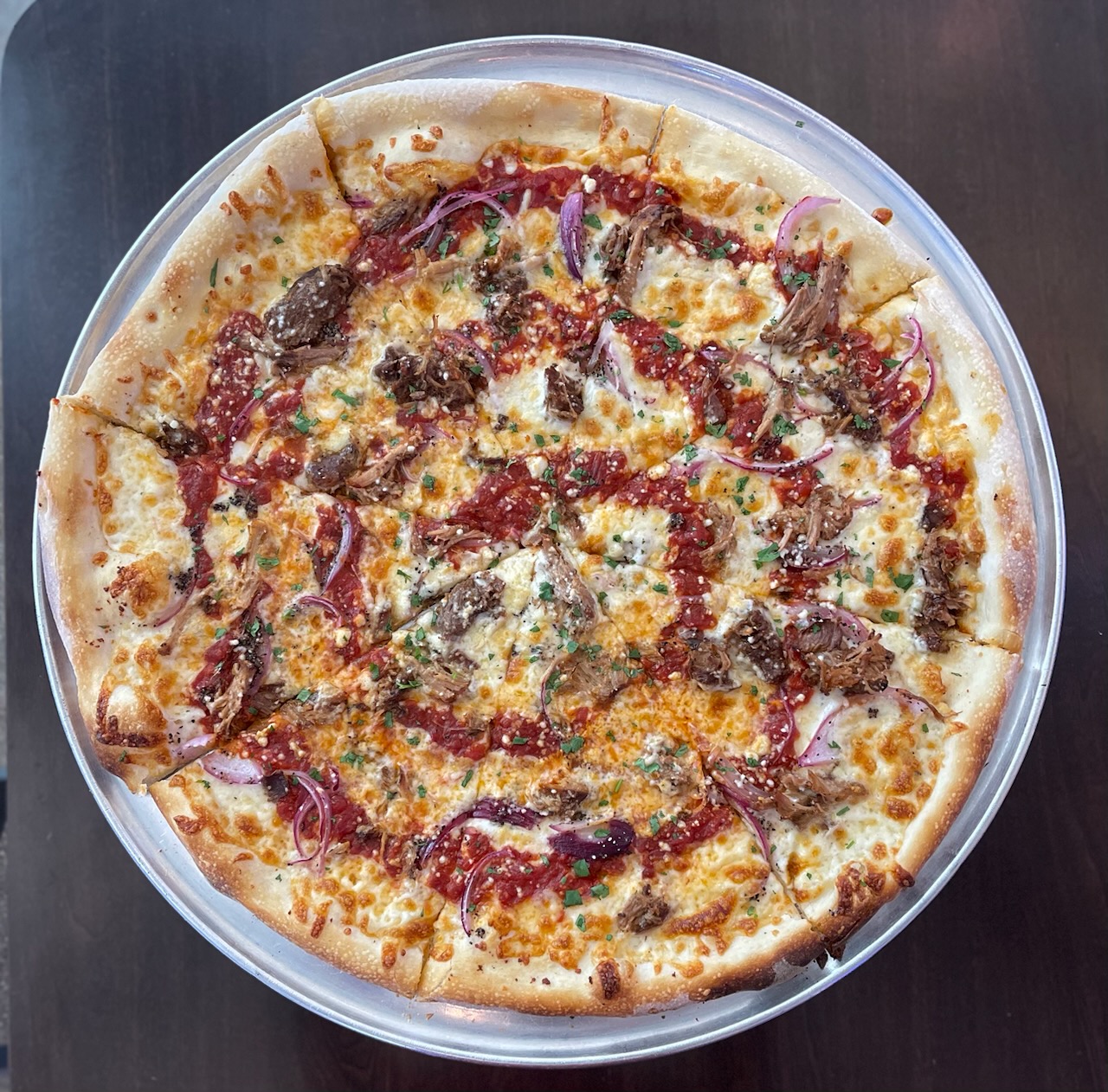 a pizza sitting on top of a pan on a table
