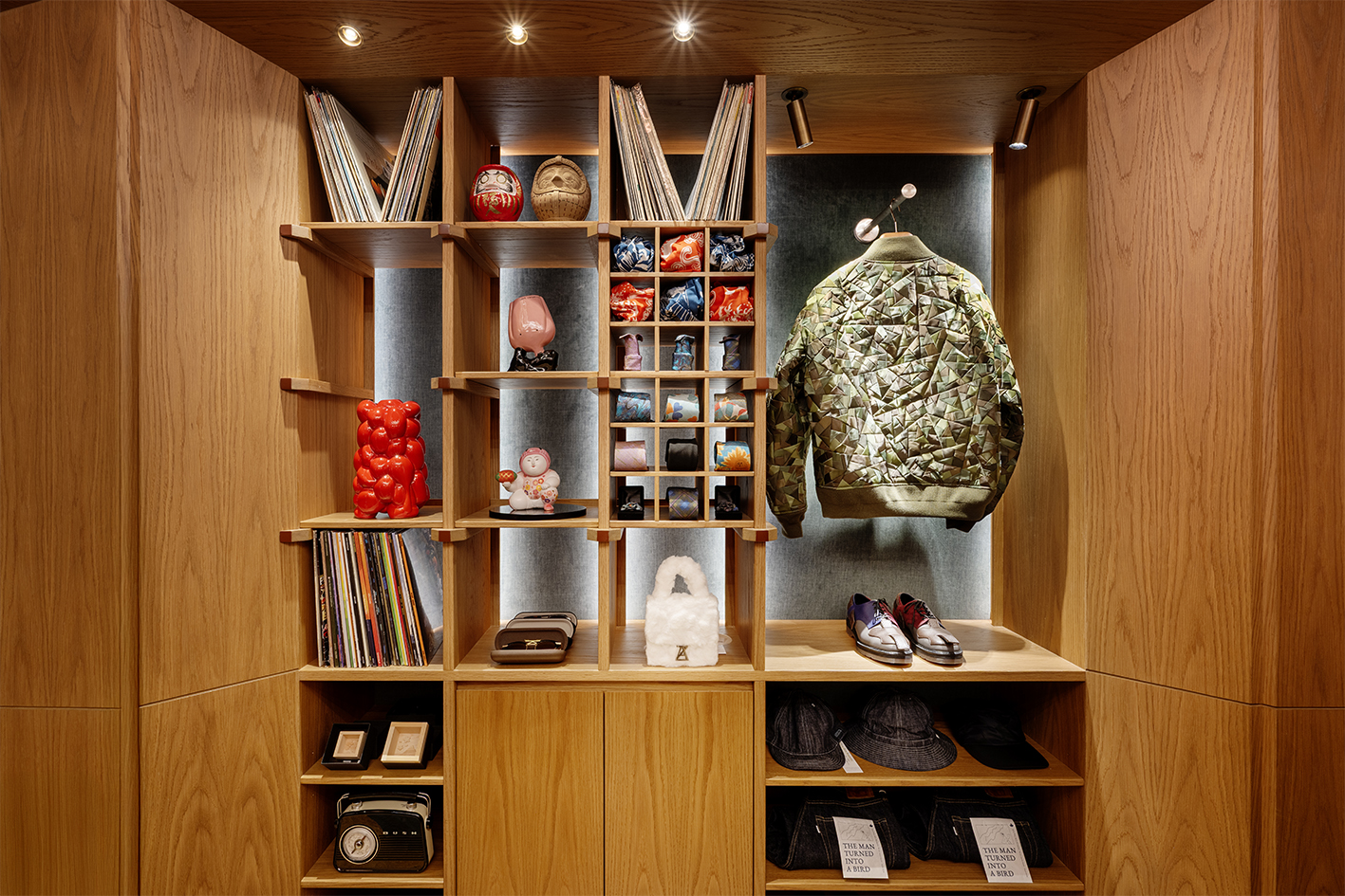 a shelf with a jacket and books and objects on it