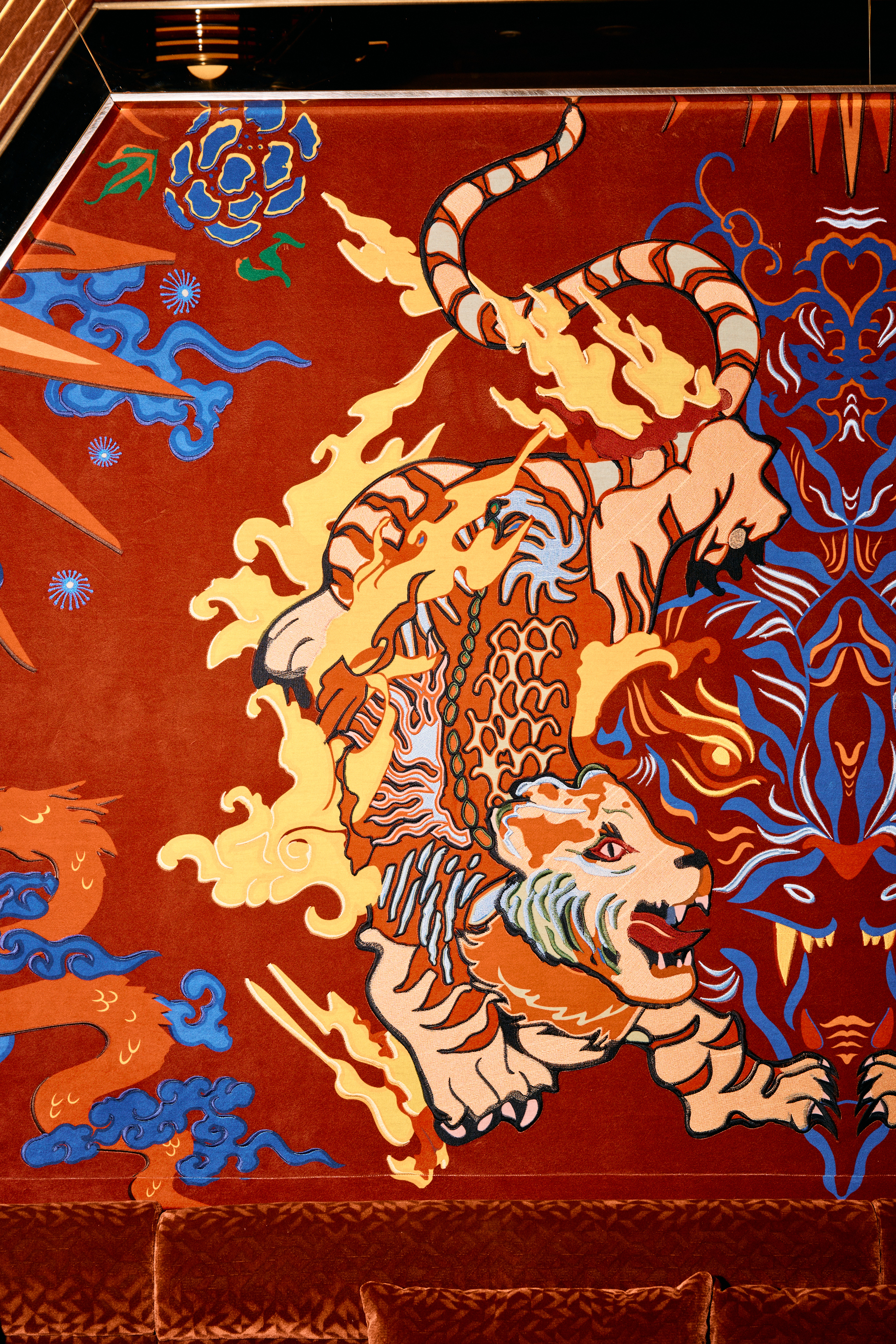 a red fabric with tiger and dragon