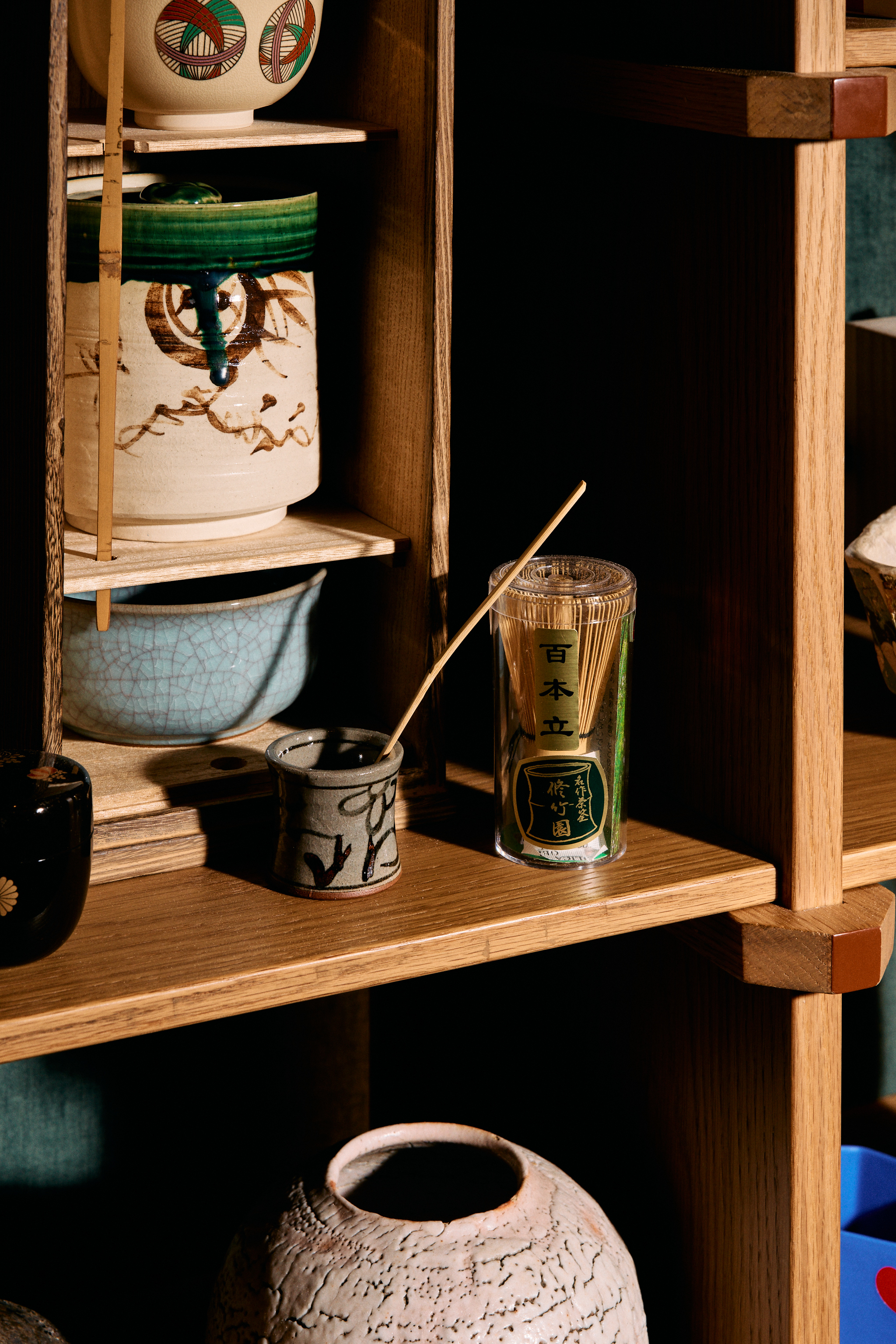 a shelf with a jar and a can of incense