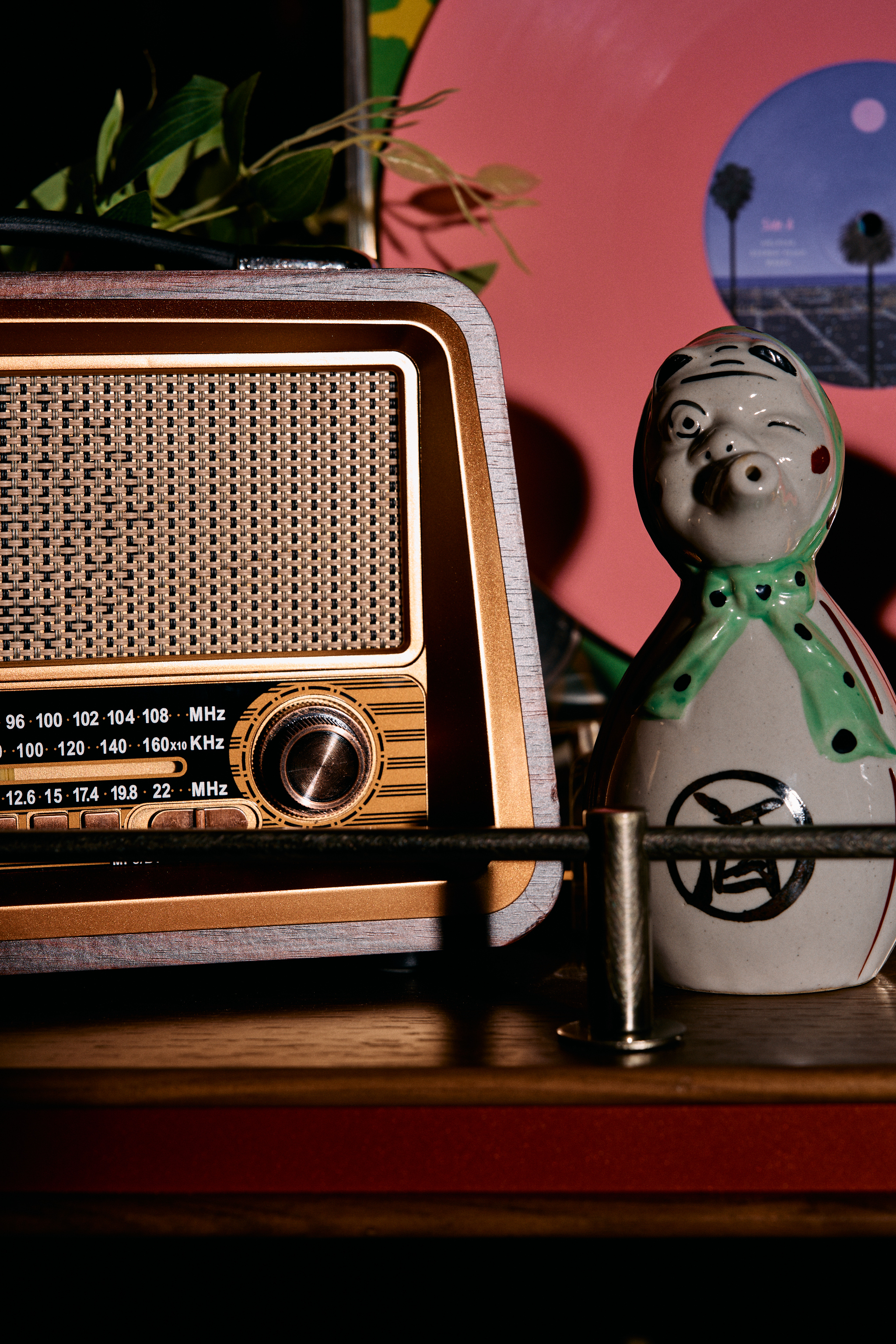 a small ceramic figurine next to a radio