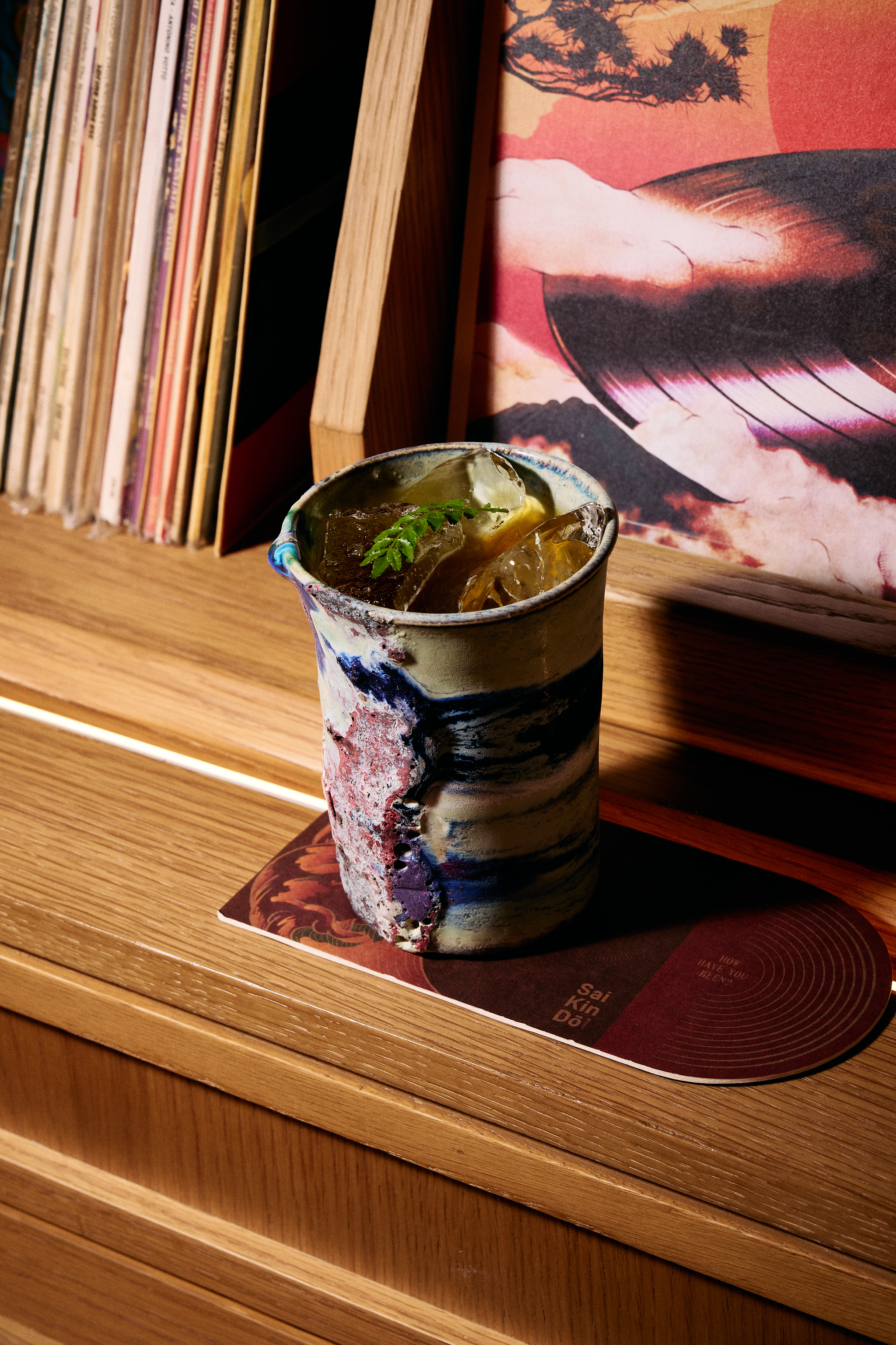 a cup with ice and a leaf on it