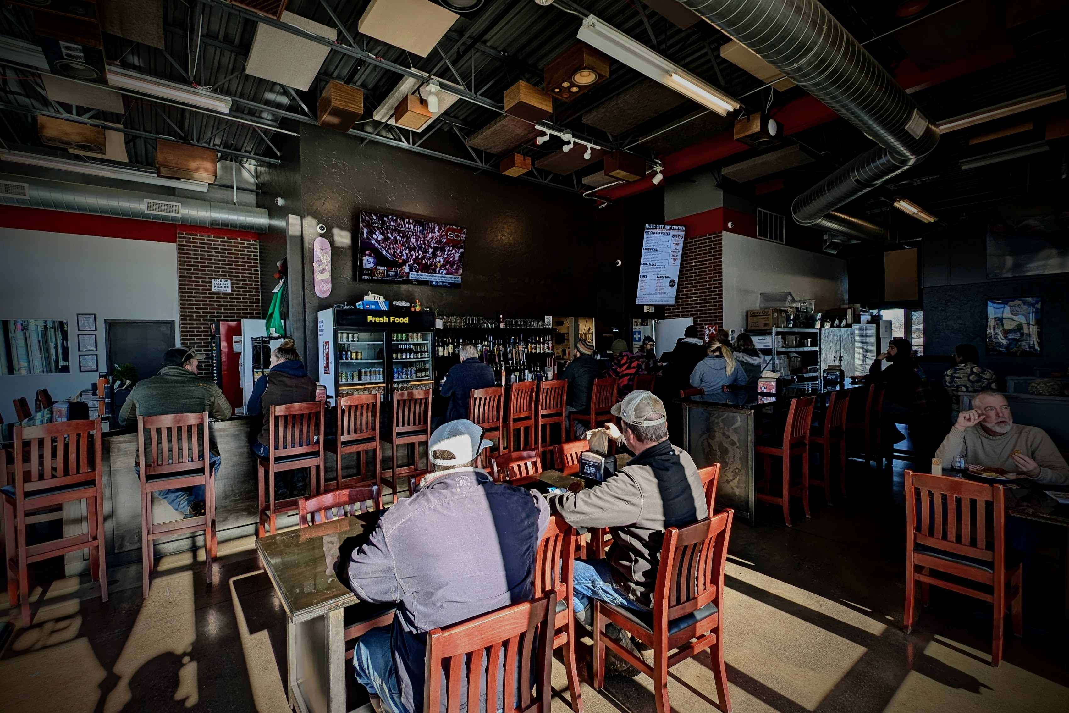 a group of people sitting at a table in a restaurant
