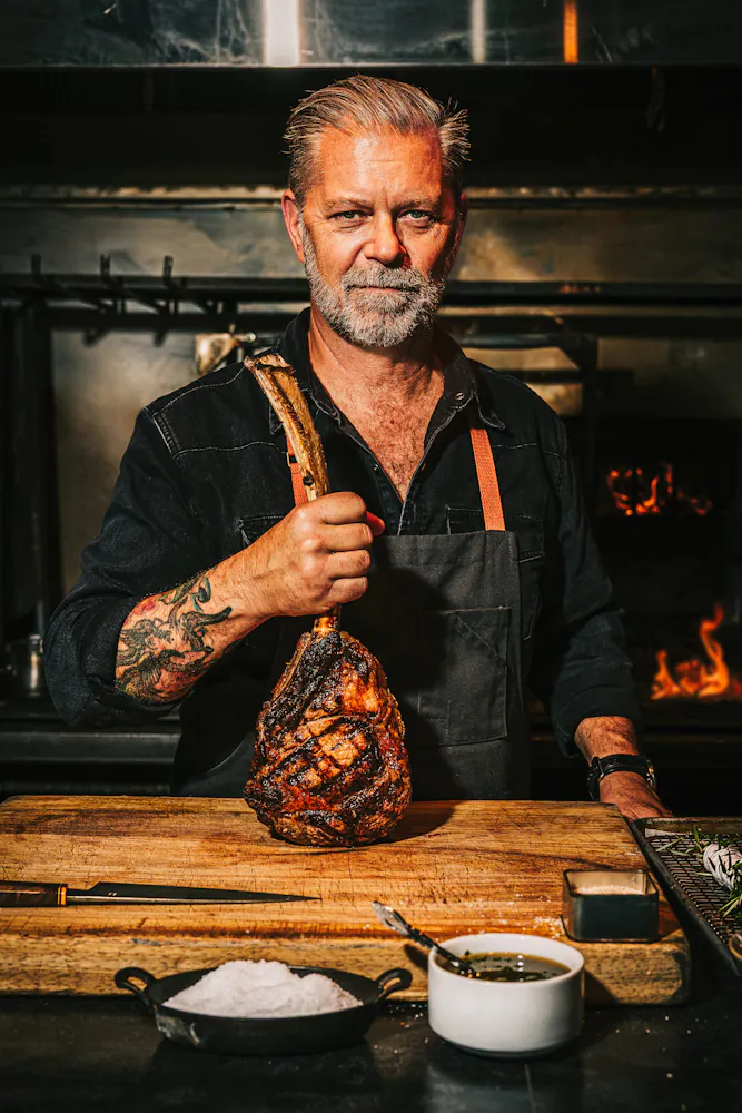 a man holding a piece of meat