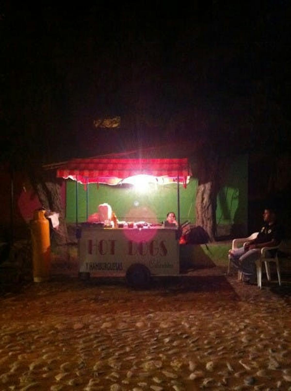 a hot dogs cart at night