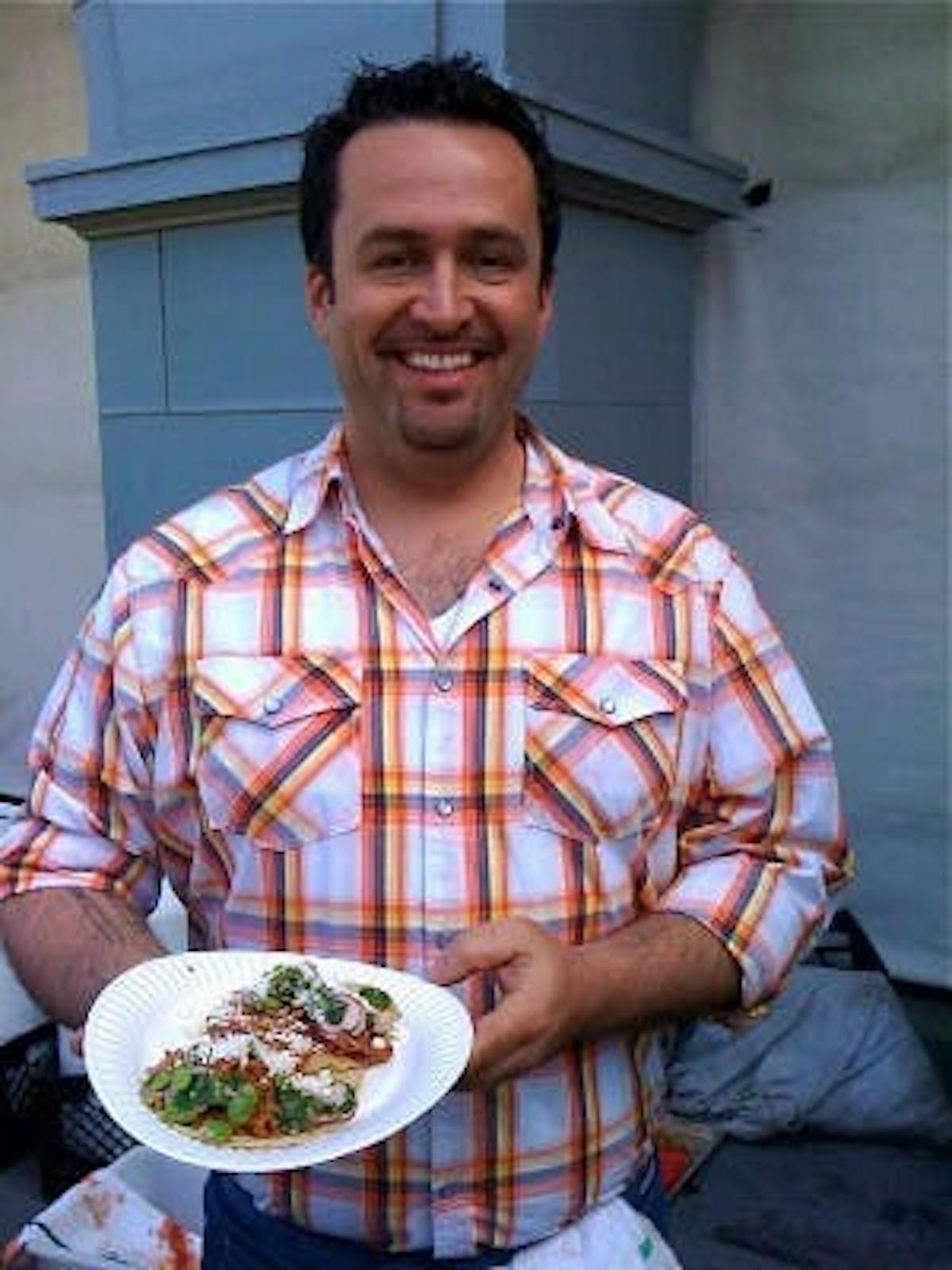 chef robbie lewis holding a taco