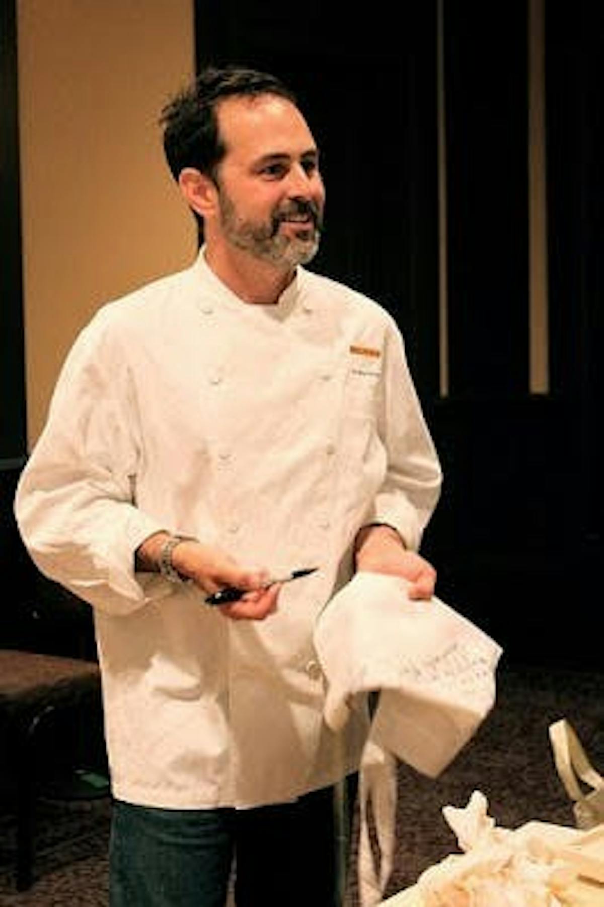 a chef holding a chef hat