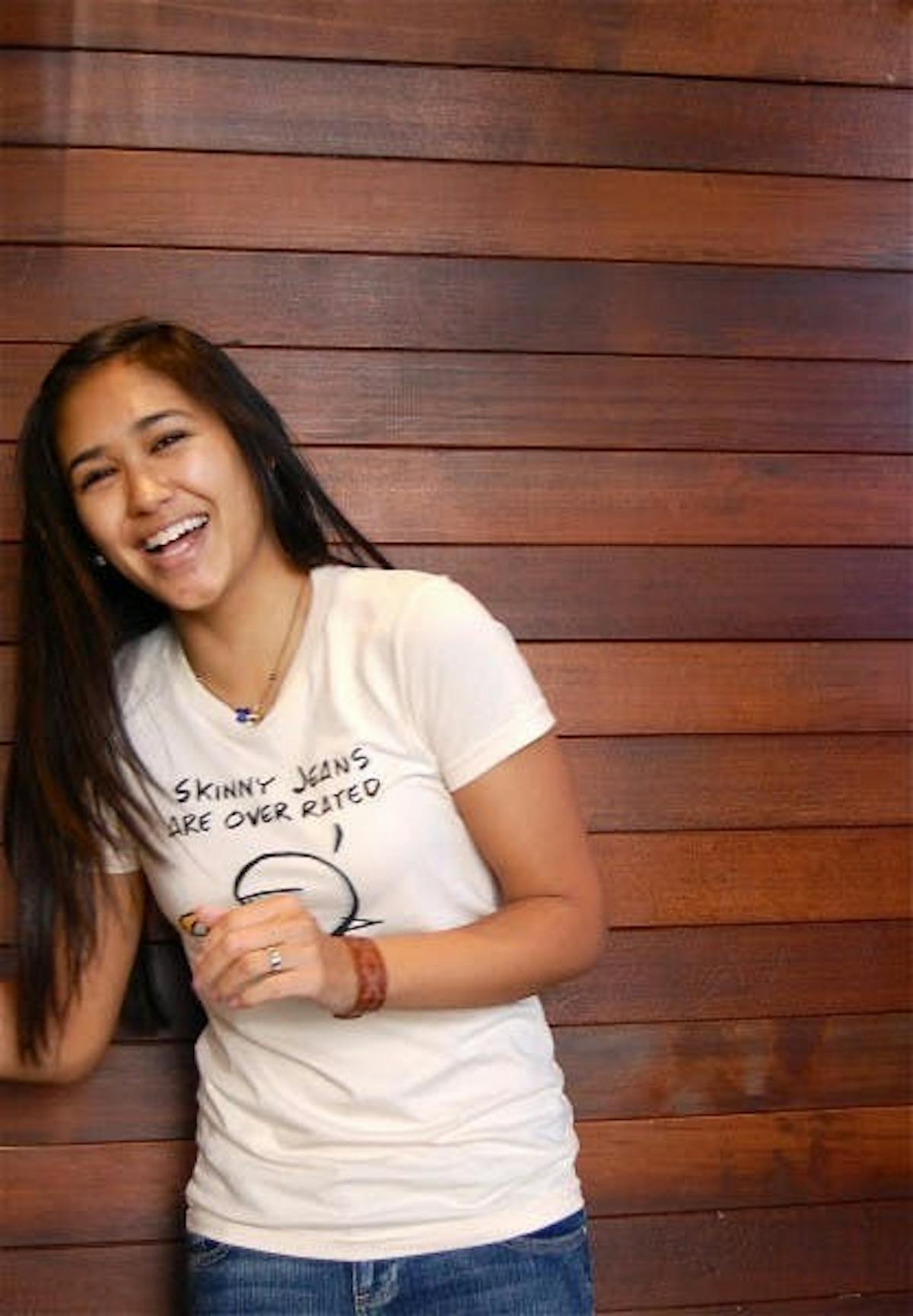 a woman wearing a shirt that says skinny jeans are over rated with an illustration of a cartoon eating tacos