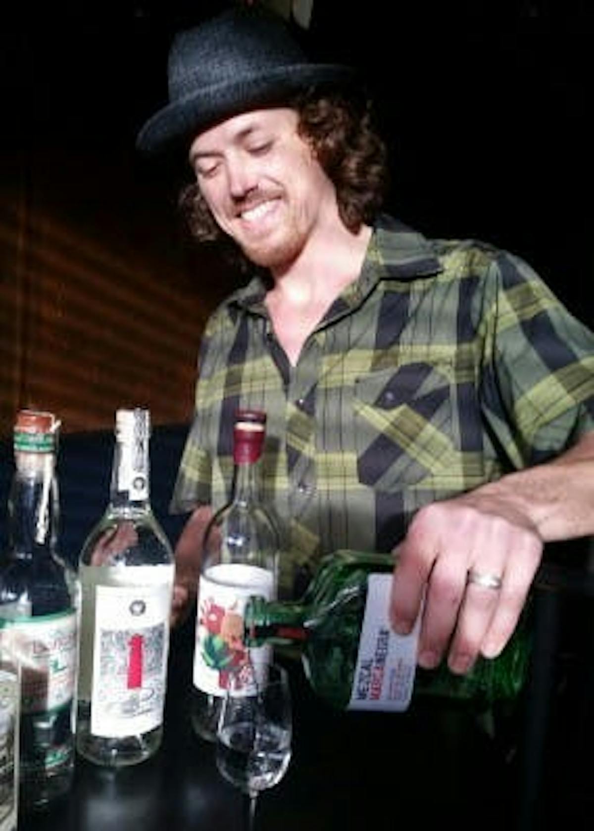 teddy our resident mezcal expert serving mezcal in a glass