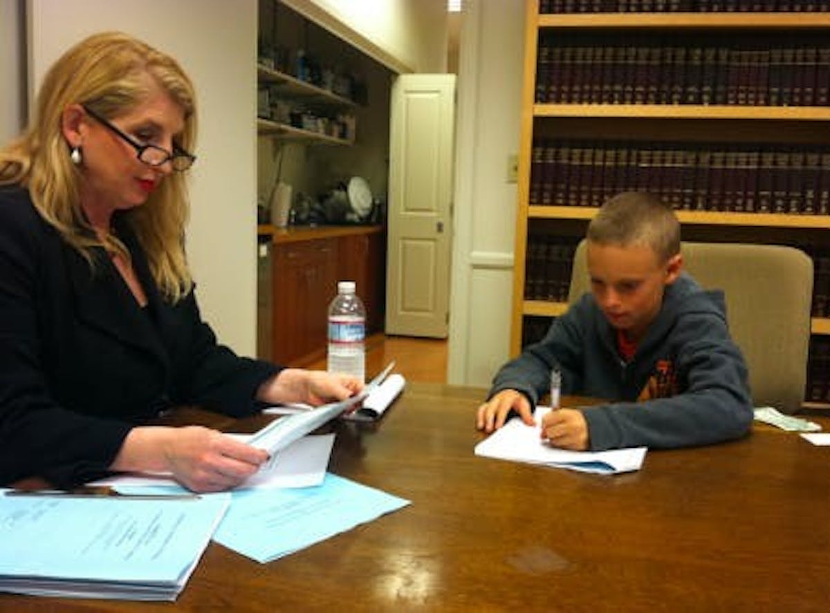 Roberta and Silas signing the documents.