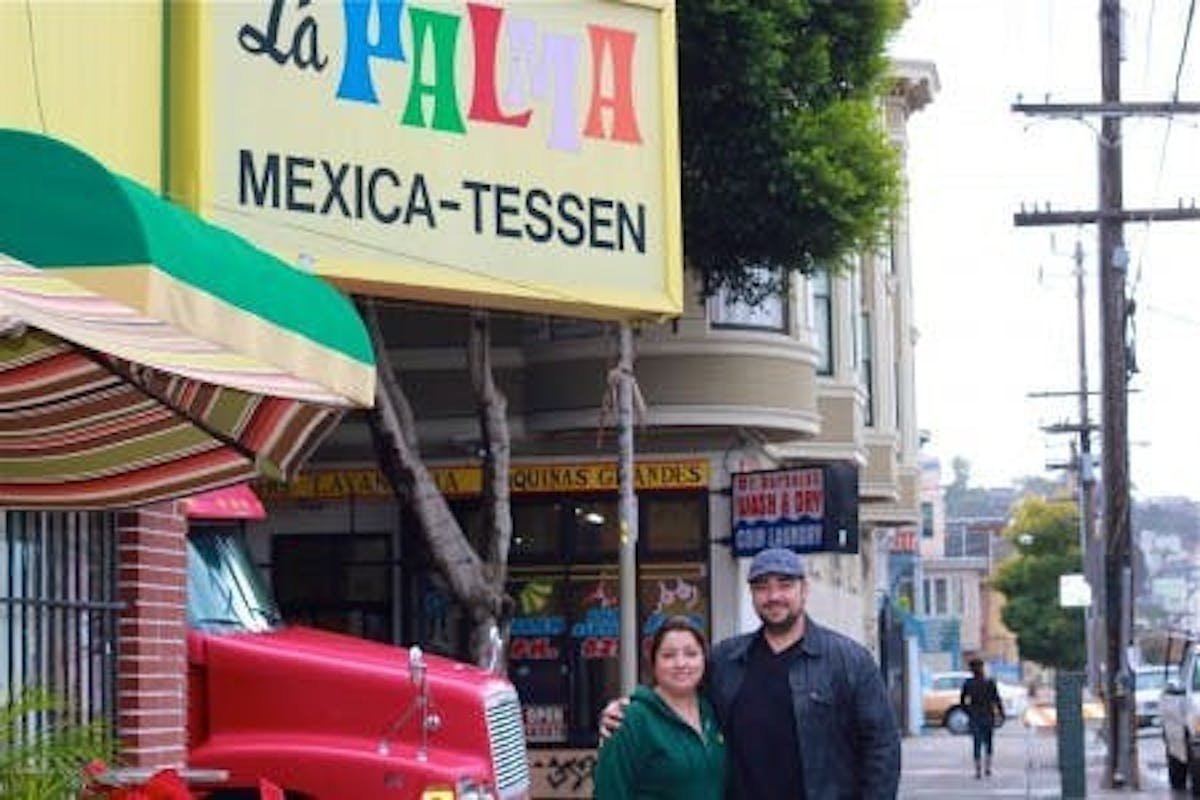 a photo of terry and telma outside of la palma mexica-tessen