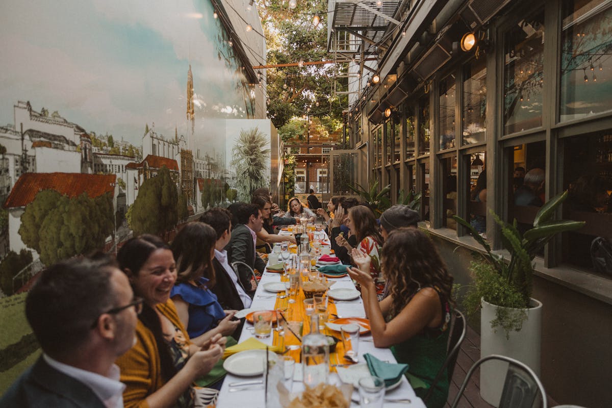 A group of people sitting together, enjoying a meal