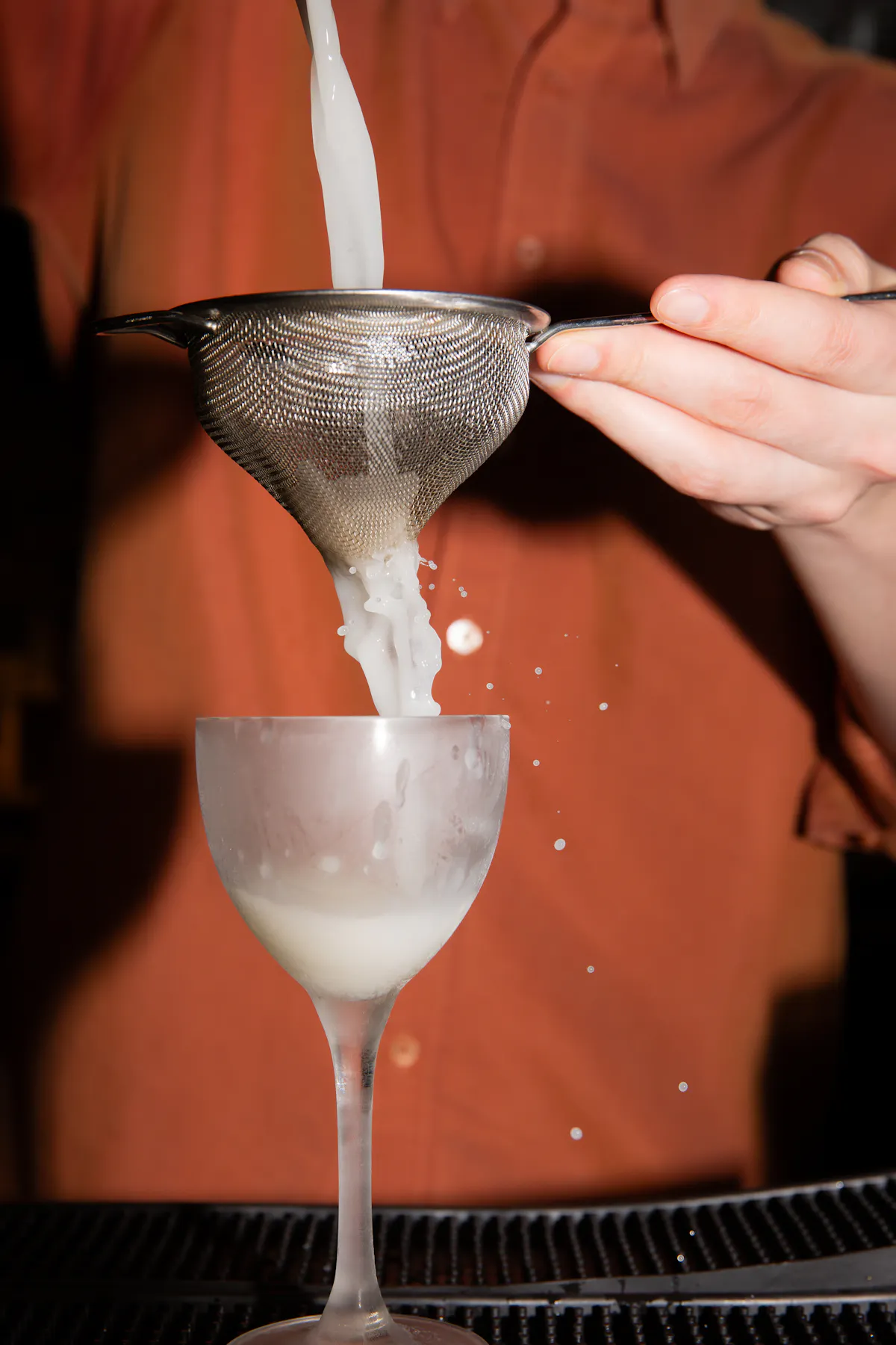 a close up of a person holding a wine glass