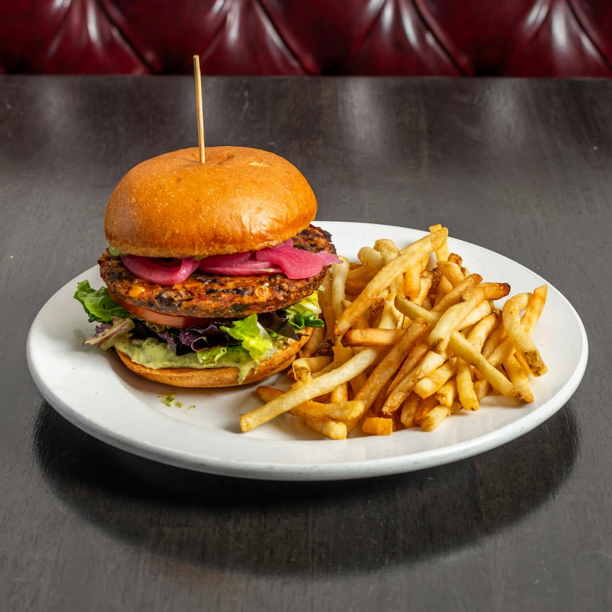 a plate with a sandwich and fries on a table