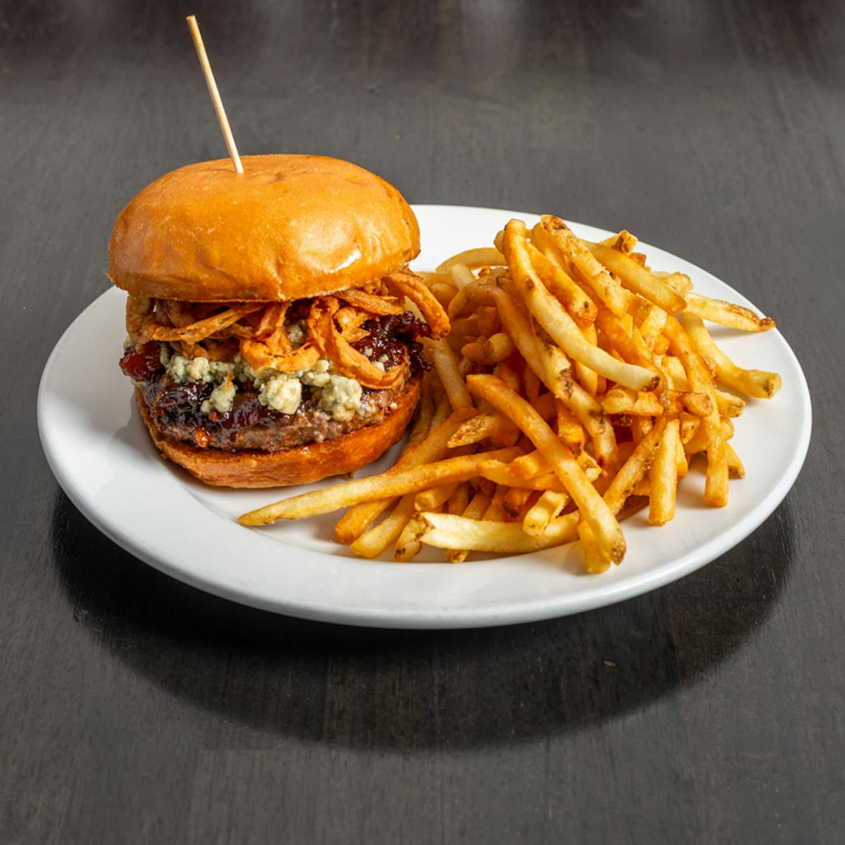 a plate with a sandwich and fries on a table