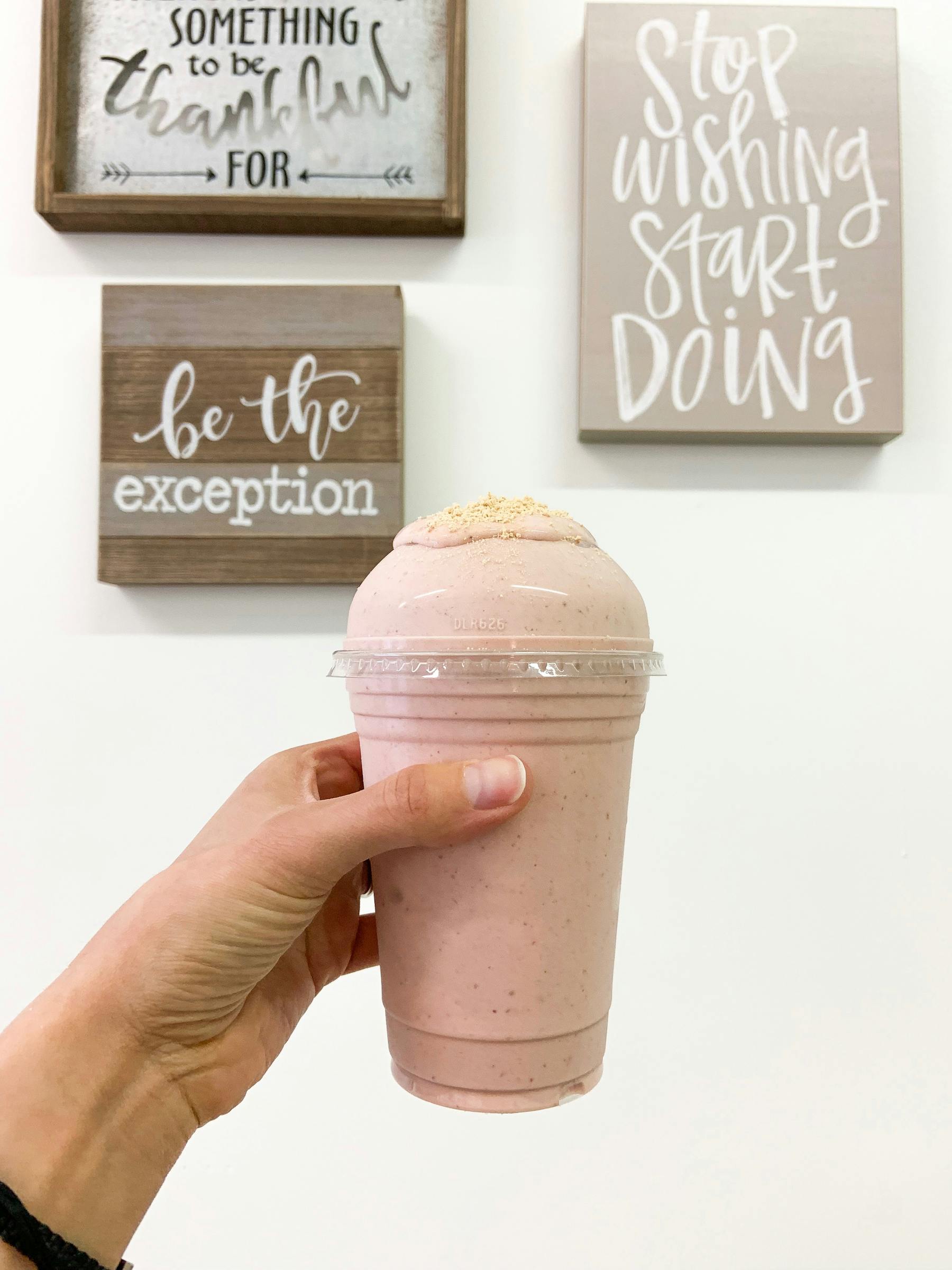 a person holding a smoothie