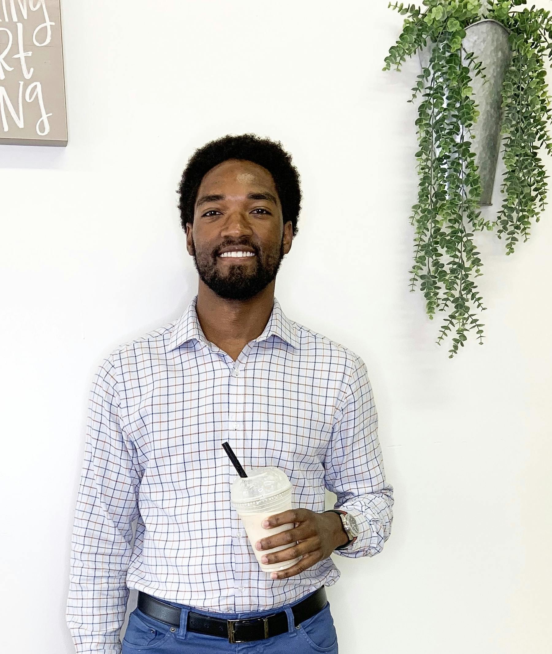 a person posing for the camera with a smoothie