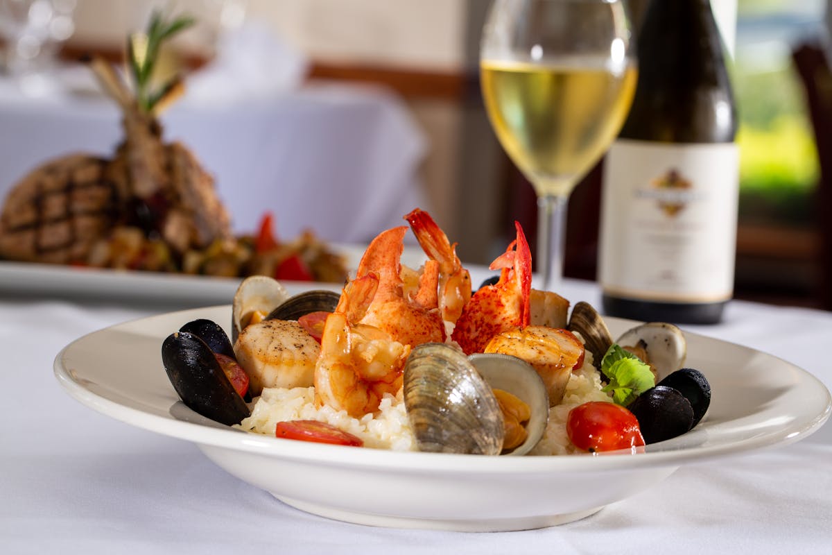 a plate of food and a glass of wine