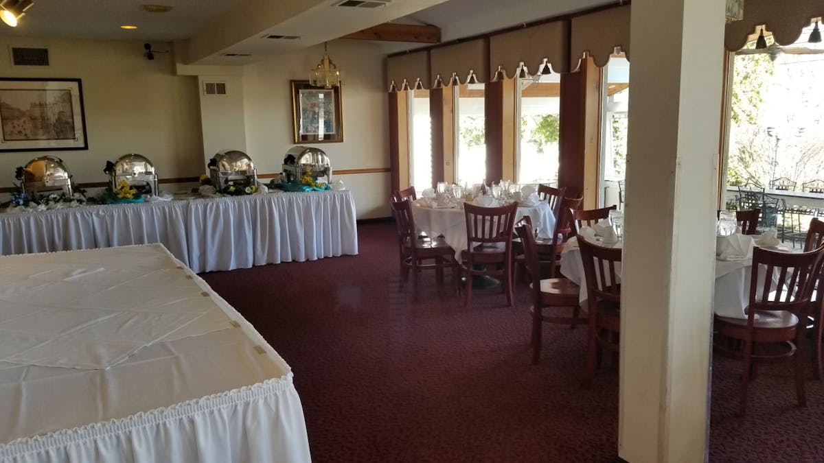 a bedroom with a bed and a chair in a room