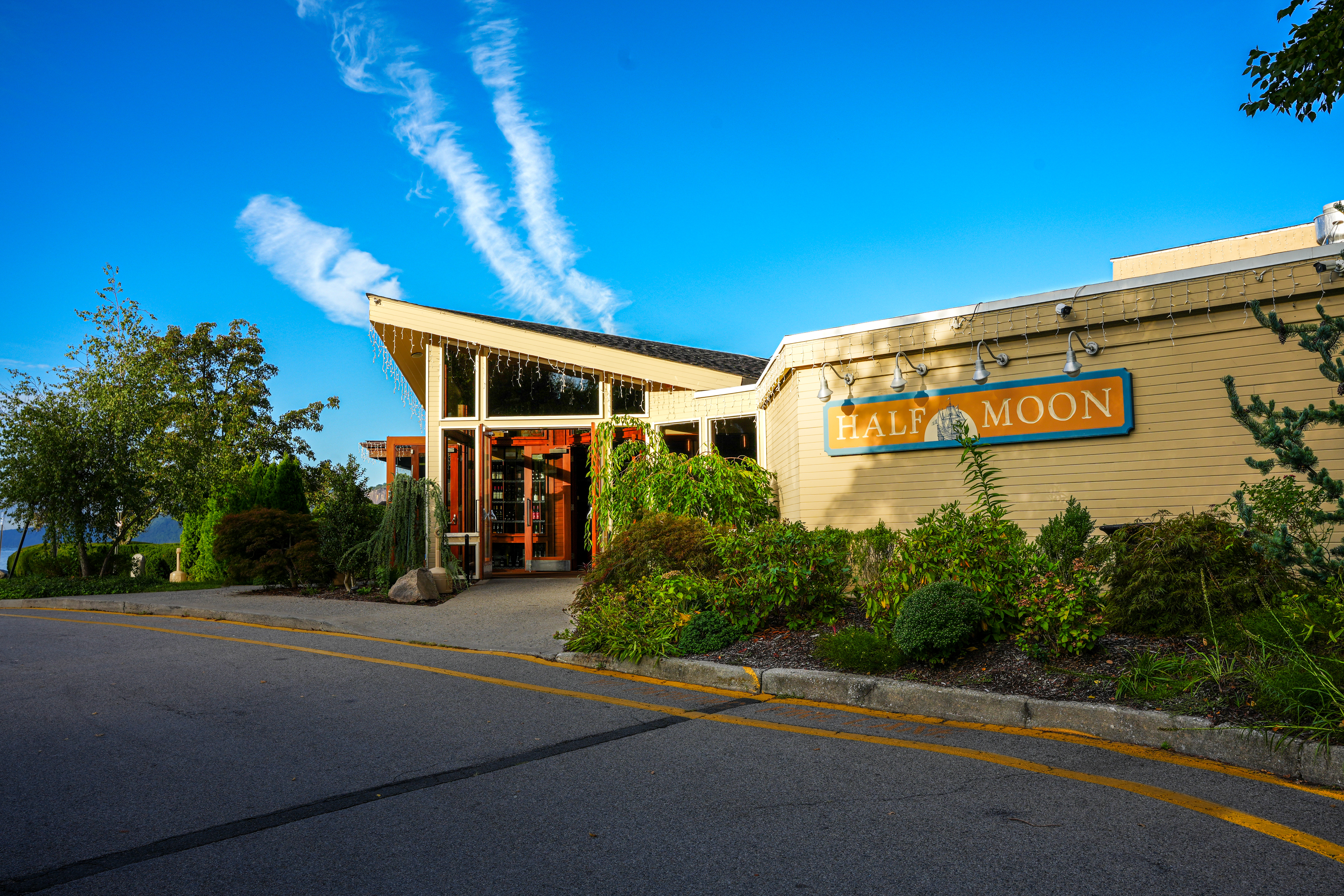 a building that has a sign on the side of a road