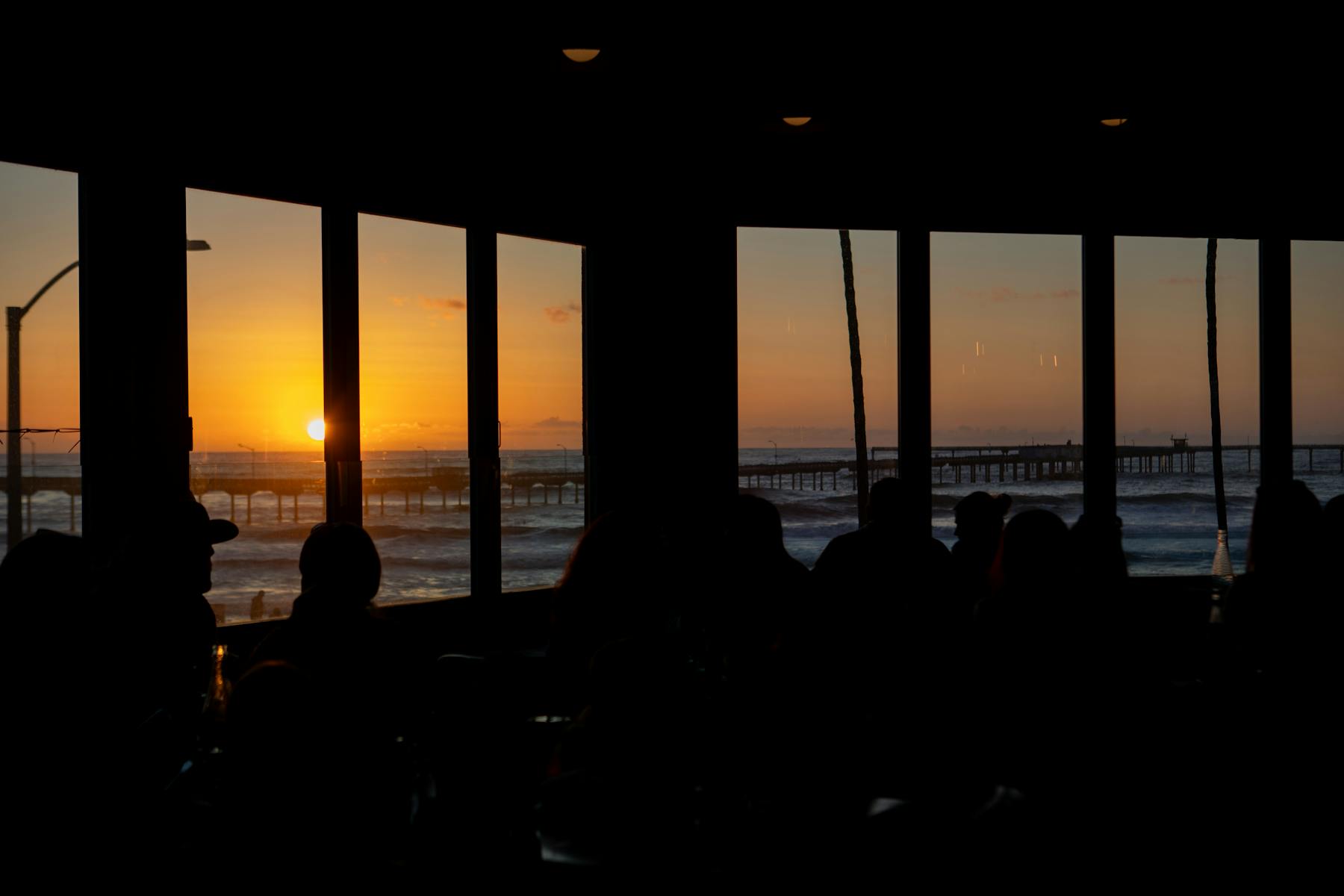a group of people standing in front of a sunset