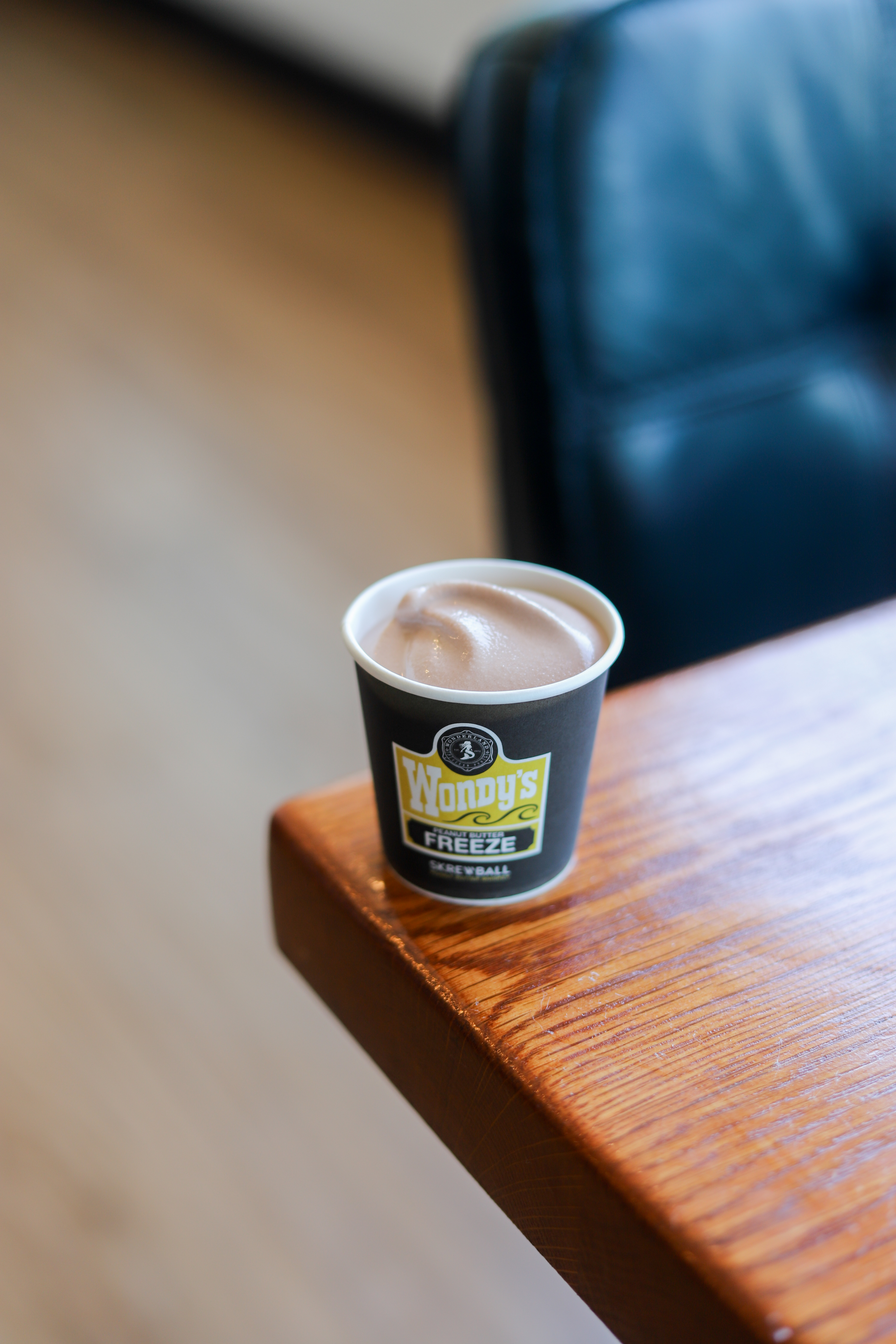 a close up of a coffee cup sitting on top of a wooden table