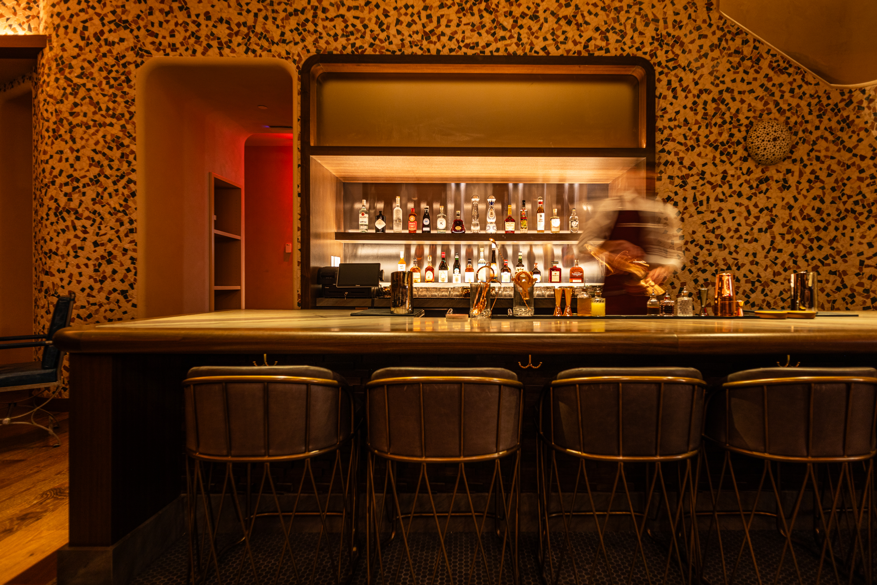 a bar with a bar and chairs