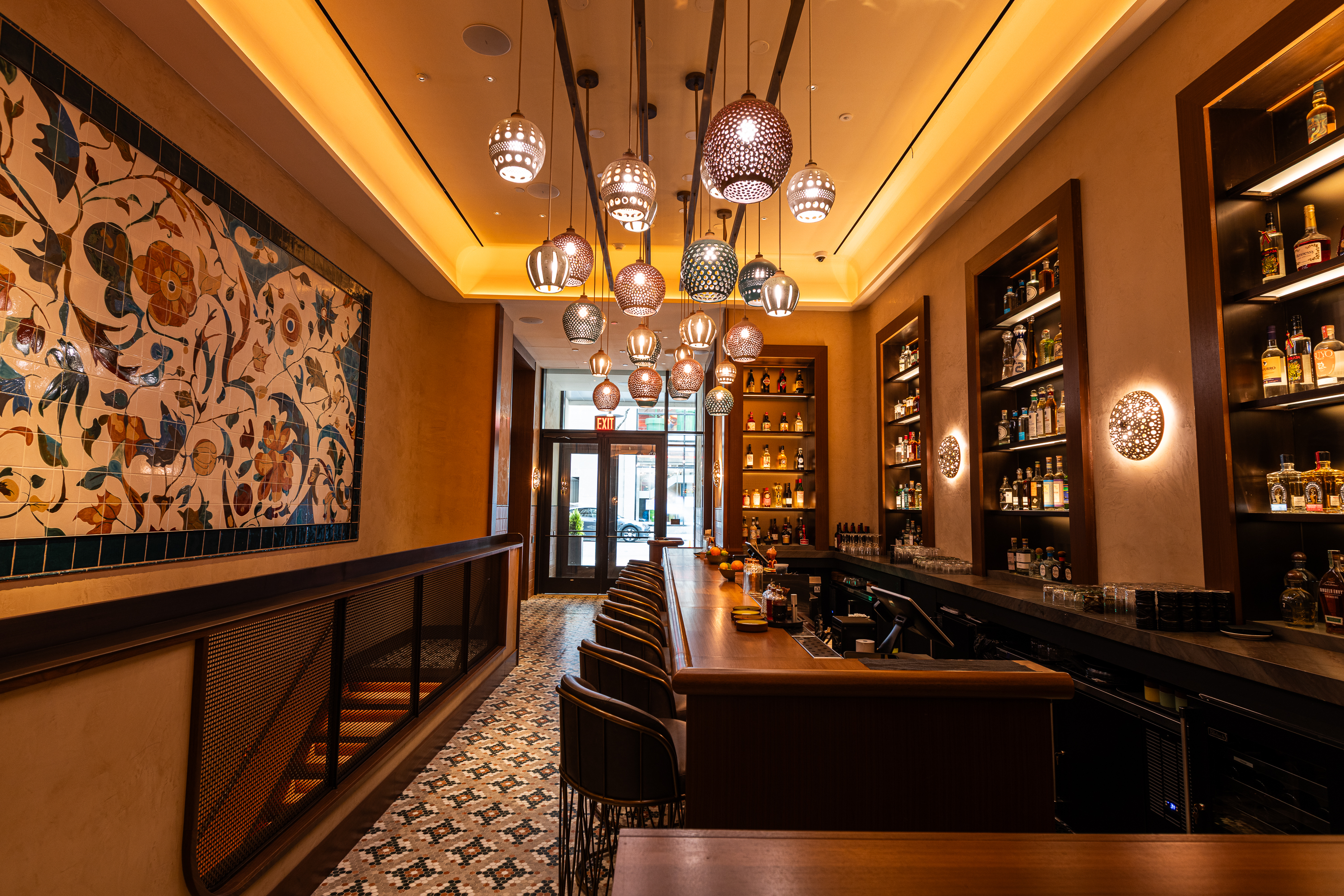 a bar with lights from the ceiling