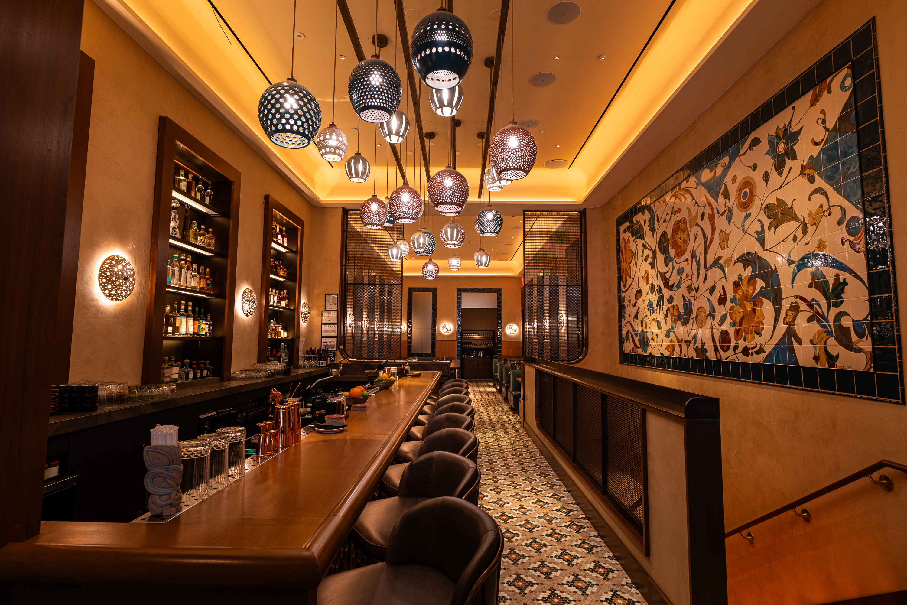a bar with a long table and chairs