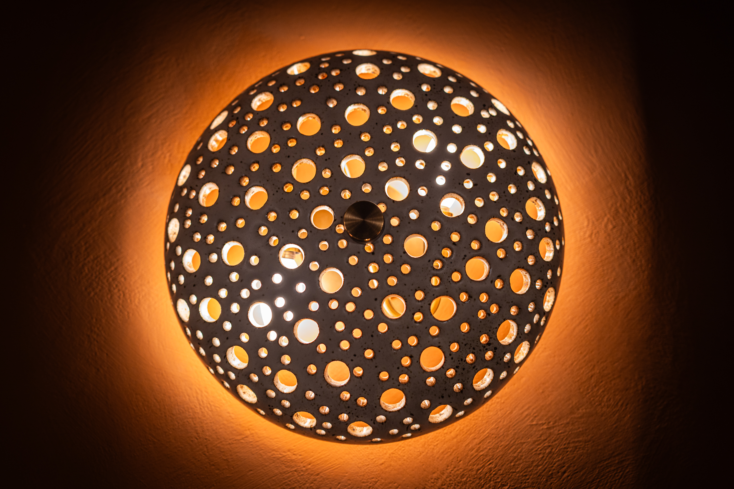 a circular light fixture with holes in it