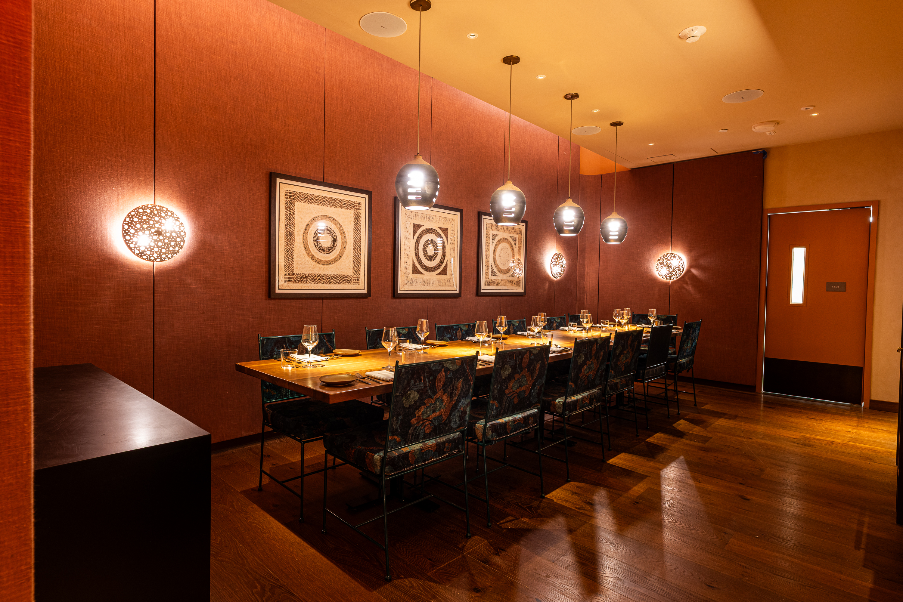 a long table with chairs and lights