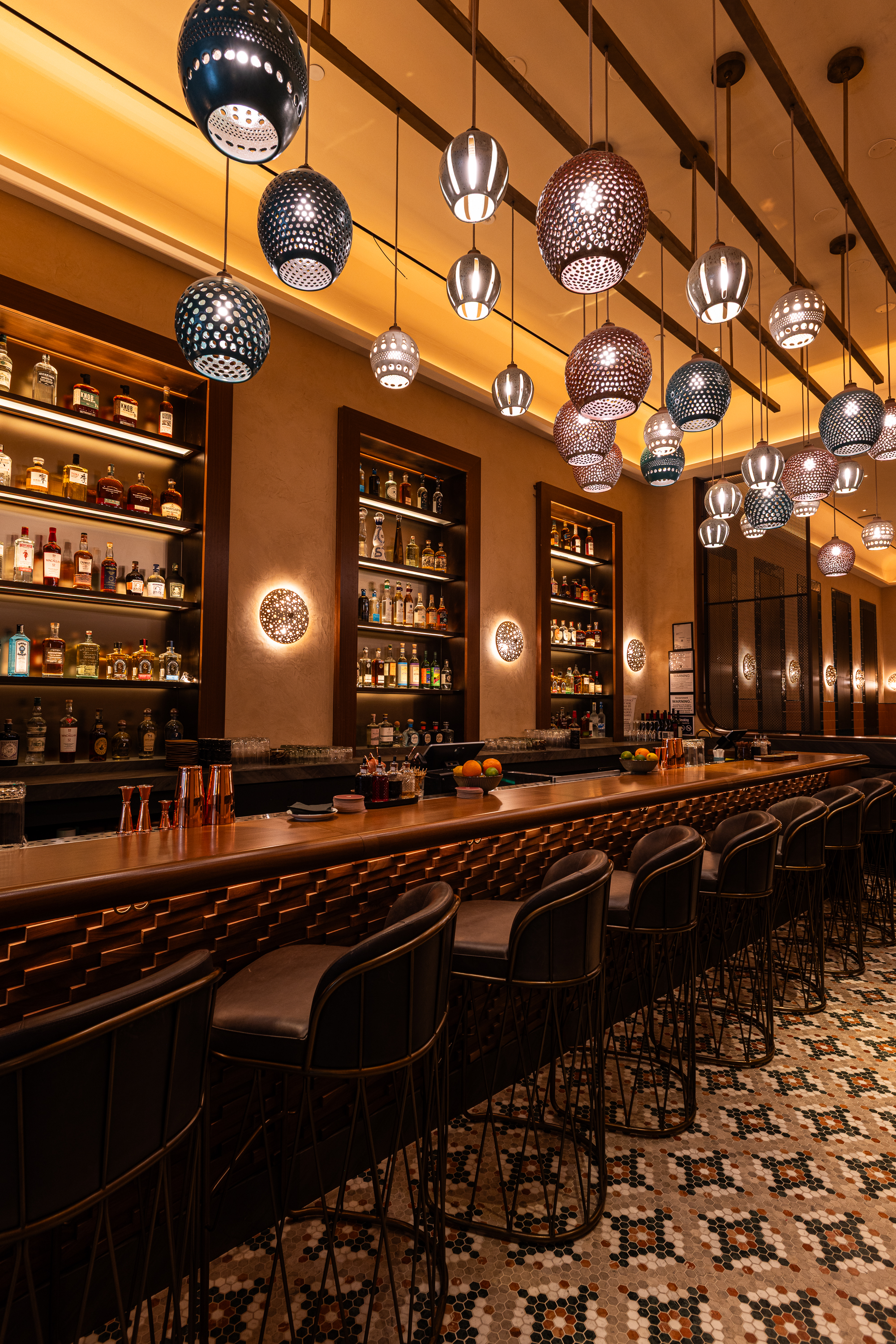 a bar with many lights from the ceiling