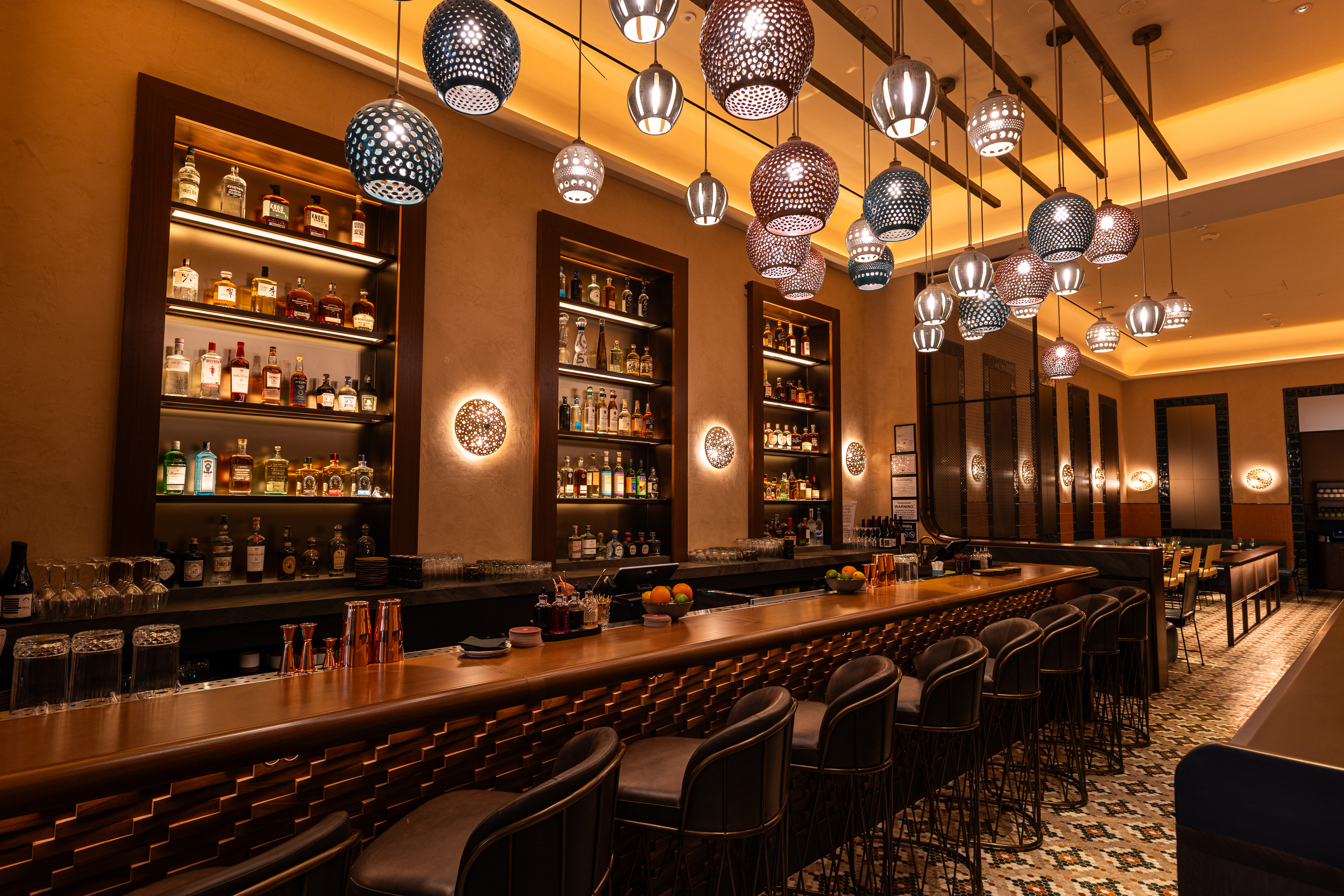 a bar with many lights from the ceiling