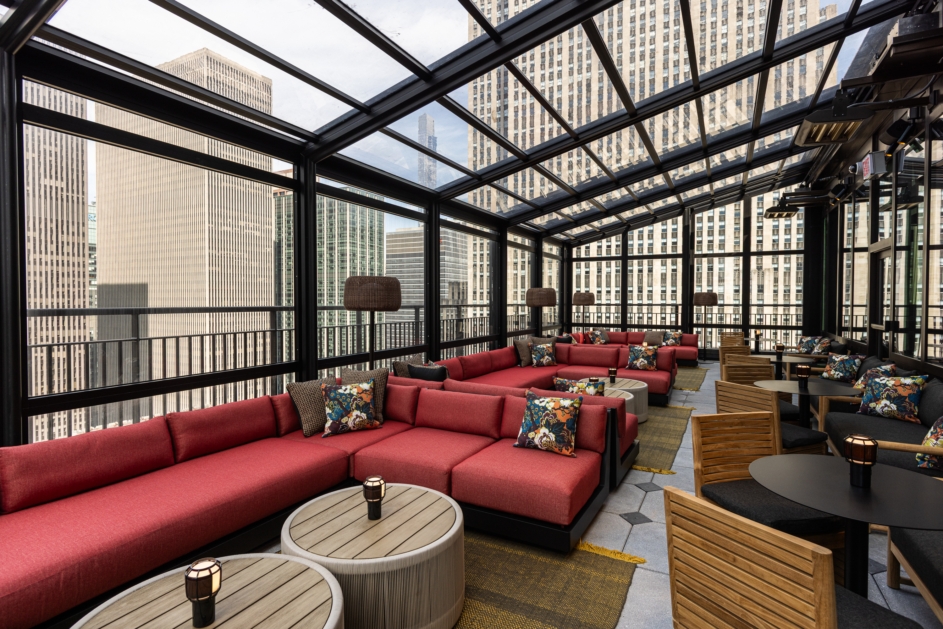 a room with a glass roof and a large group of tables and chairs