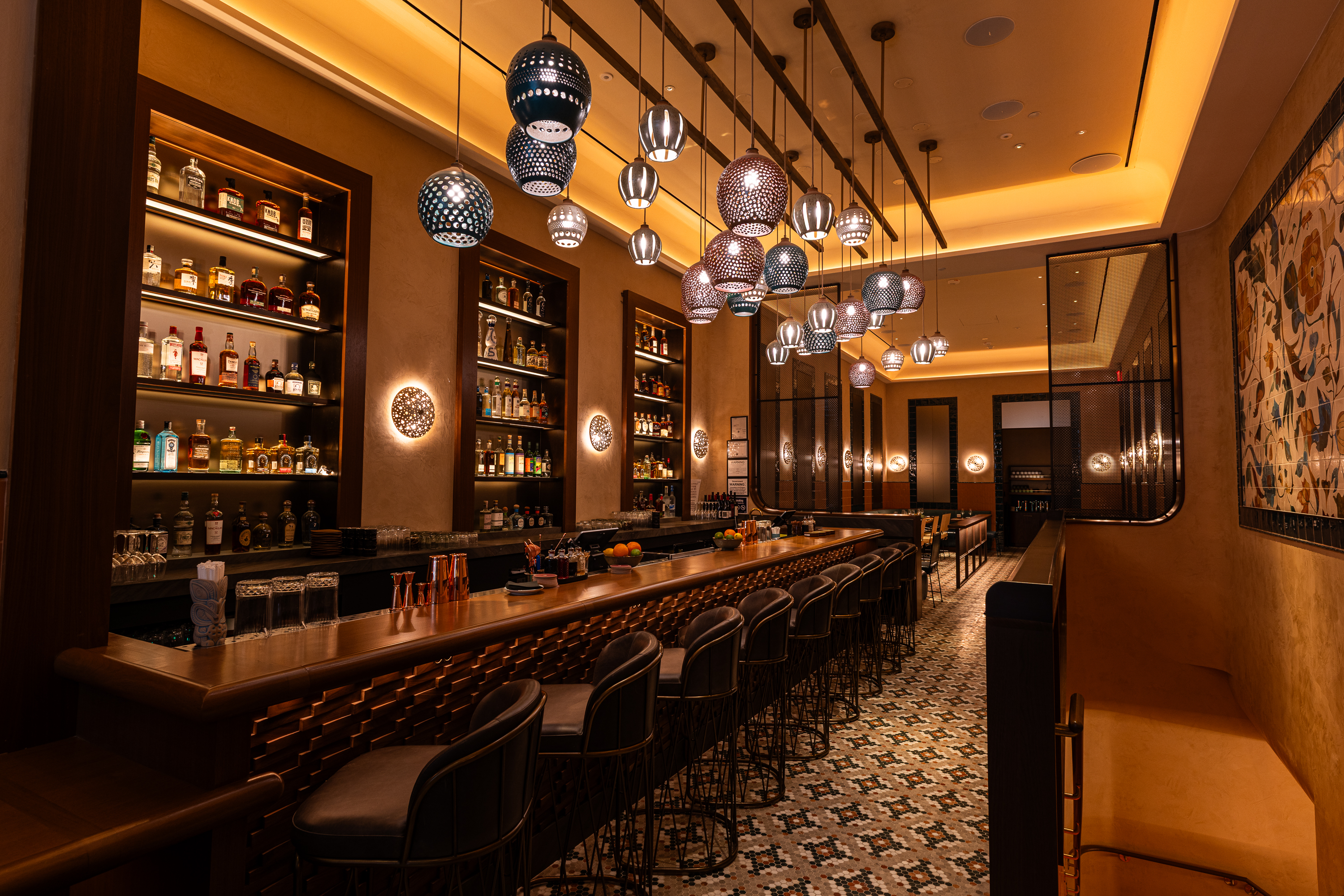 a bar with stools and lights