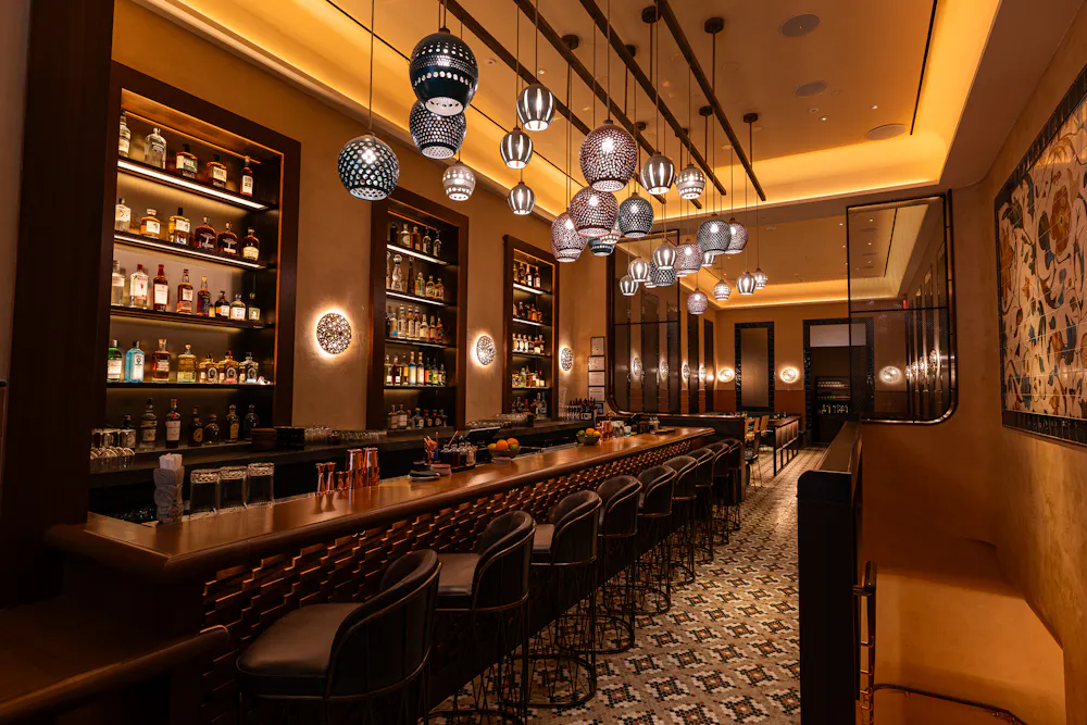 a bar with stools and lights