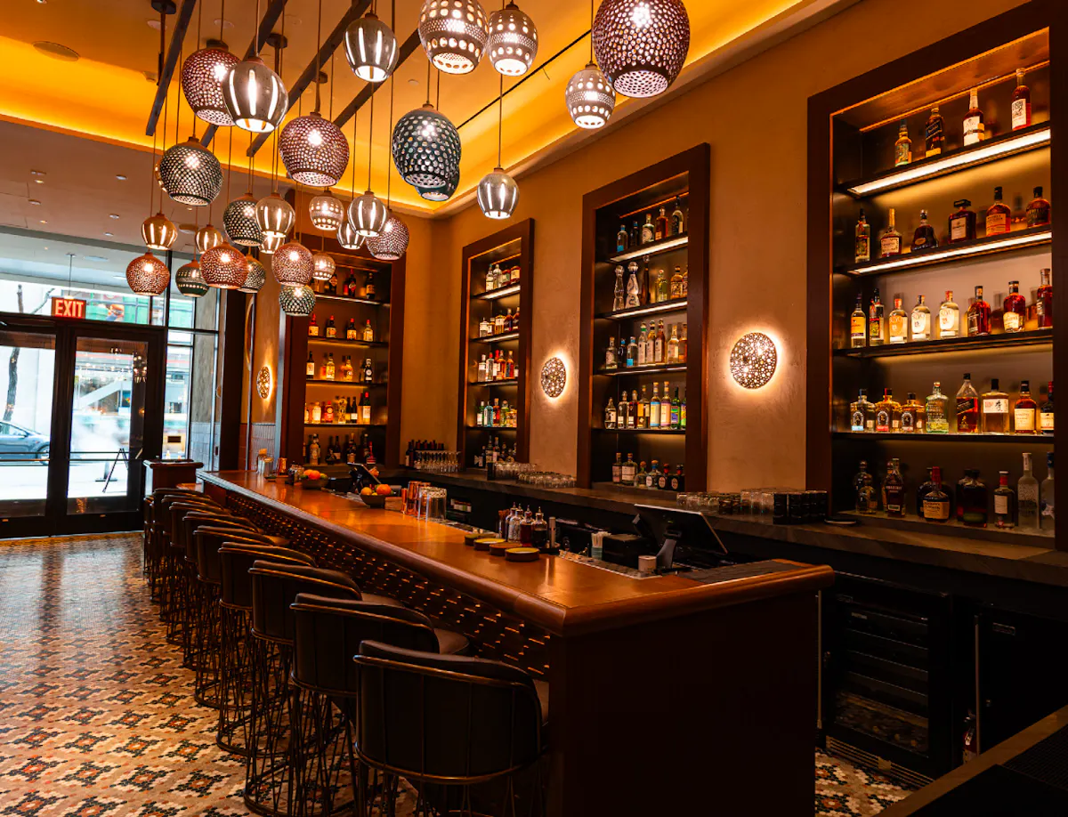 a bar with shelves and lights