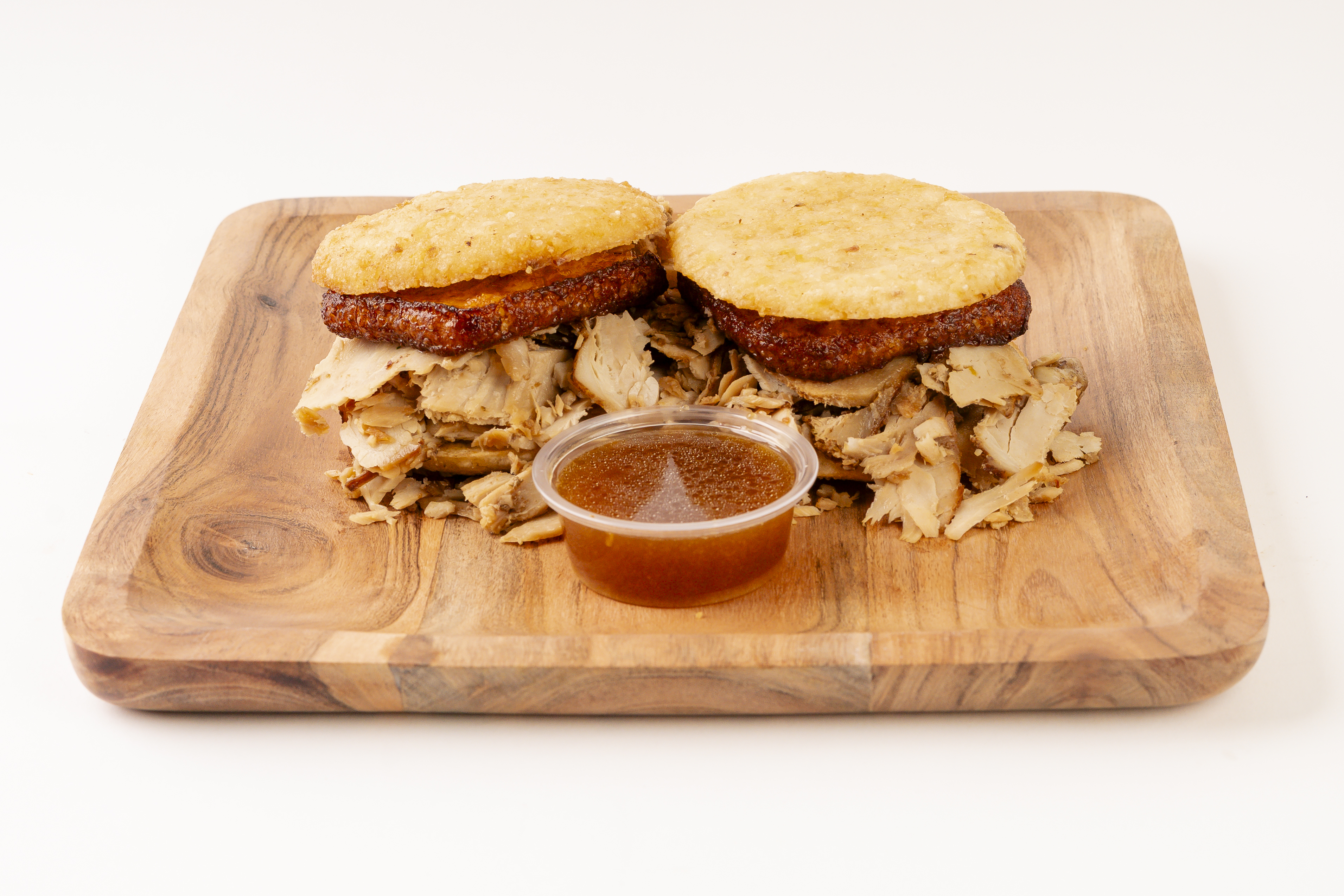 a cut in half sandwich sitting on top of a wooden cutting board