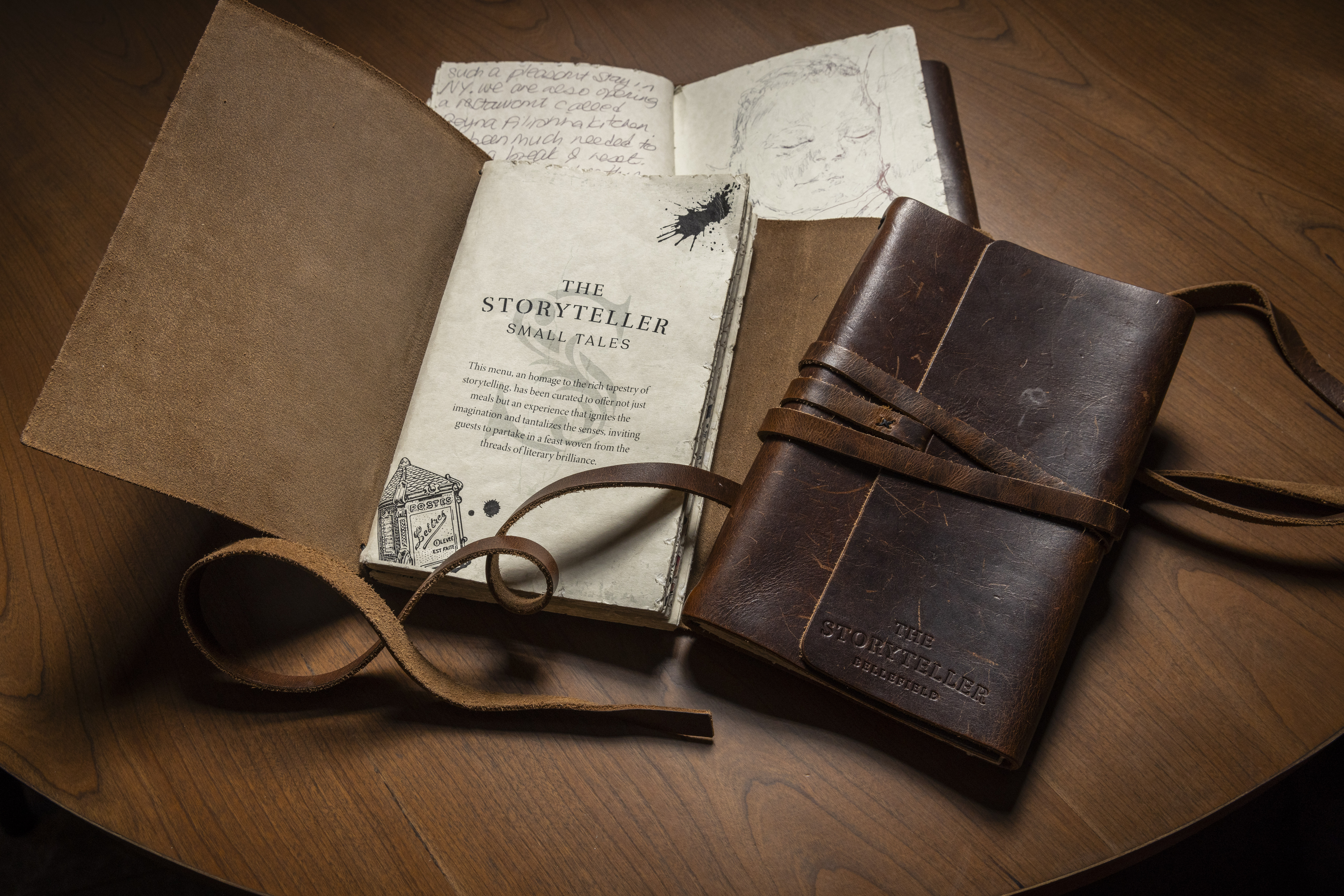 a book and leather bound journal on a table