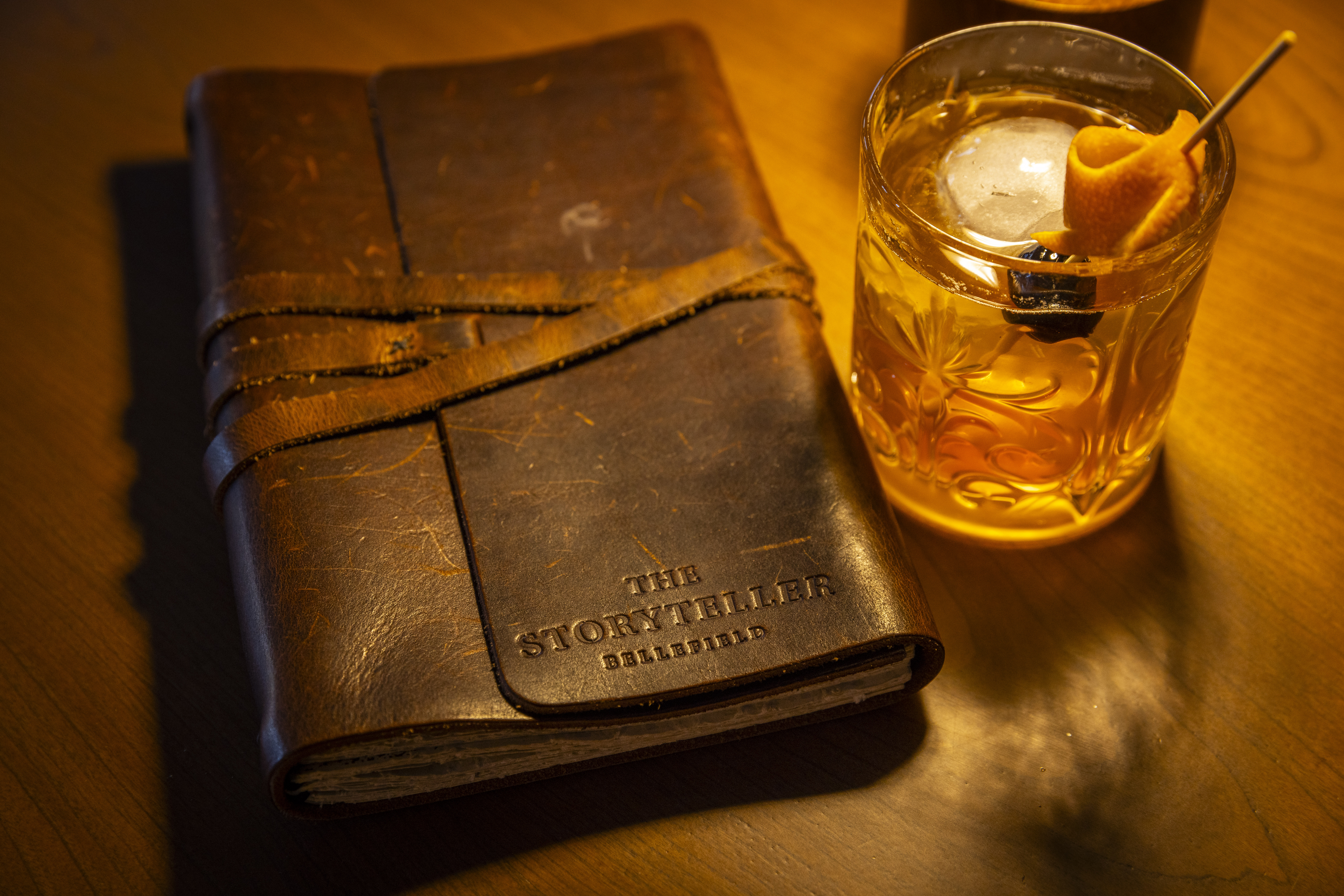 a leather journal and a drink
