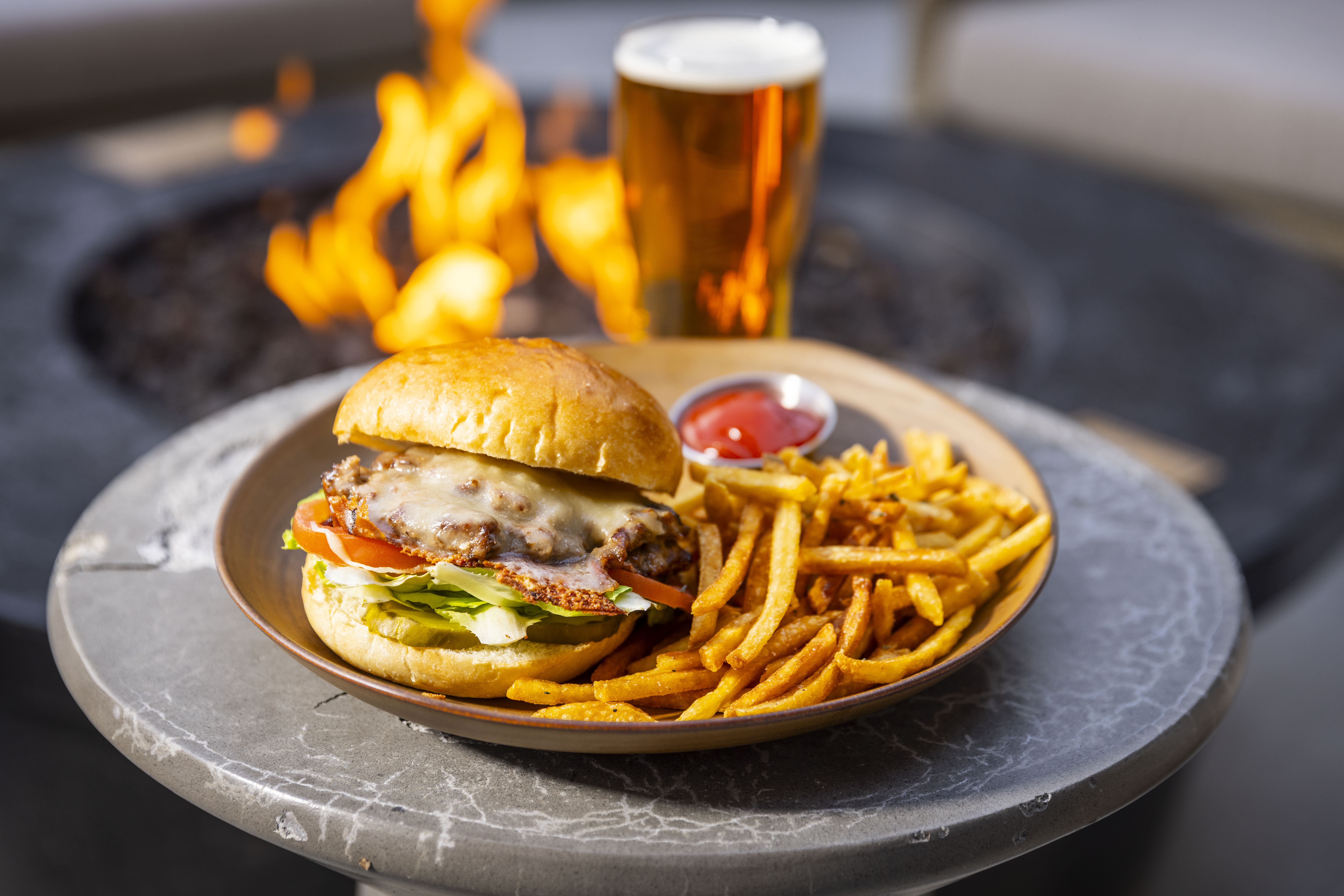 a plate of food with a glass of beer