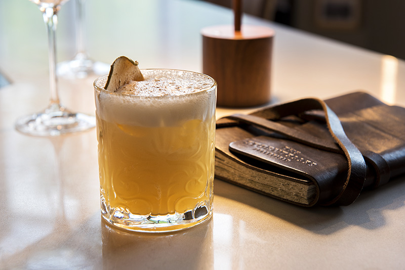 a glass of drink on a table