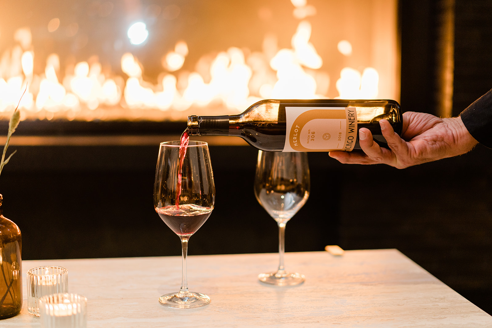 a hand holding a glass of wine